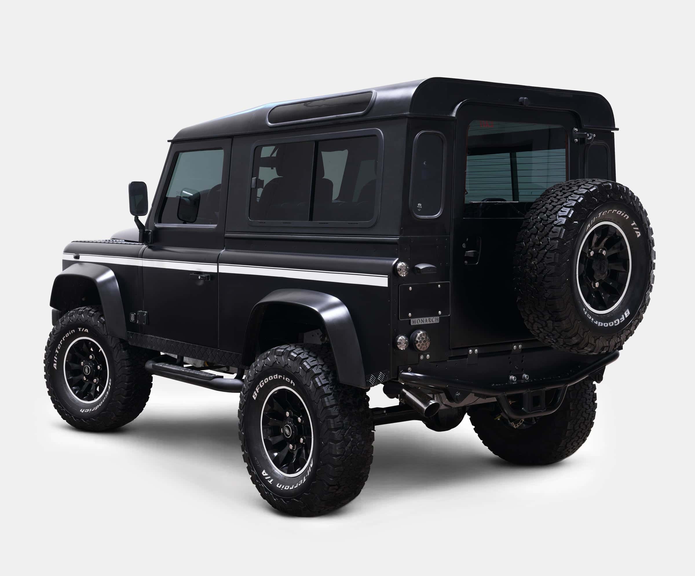 Black custom Land Rover Defender showcasing luxury design and off-road capabilities
