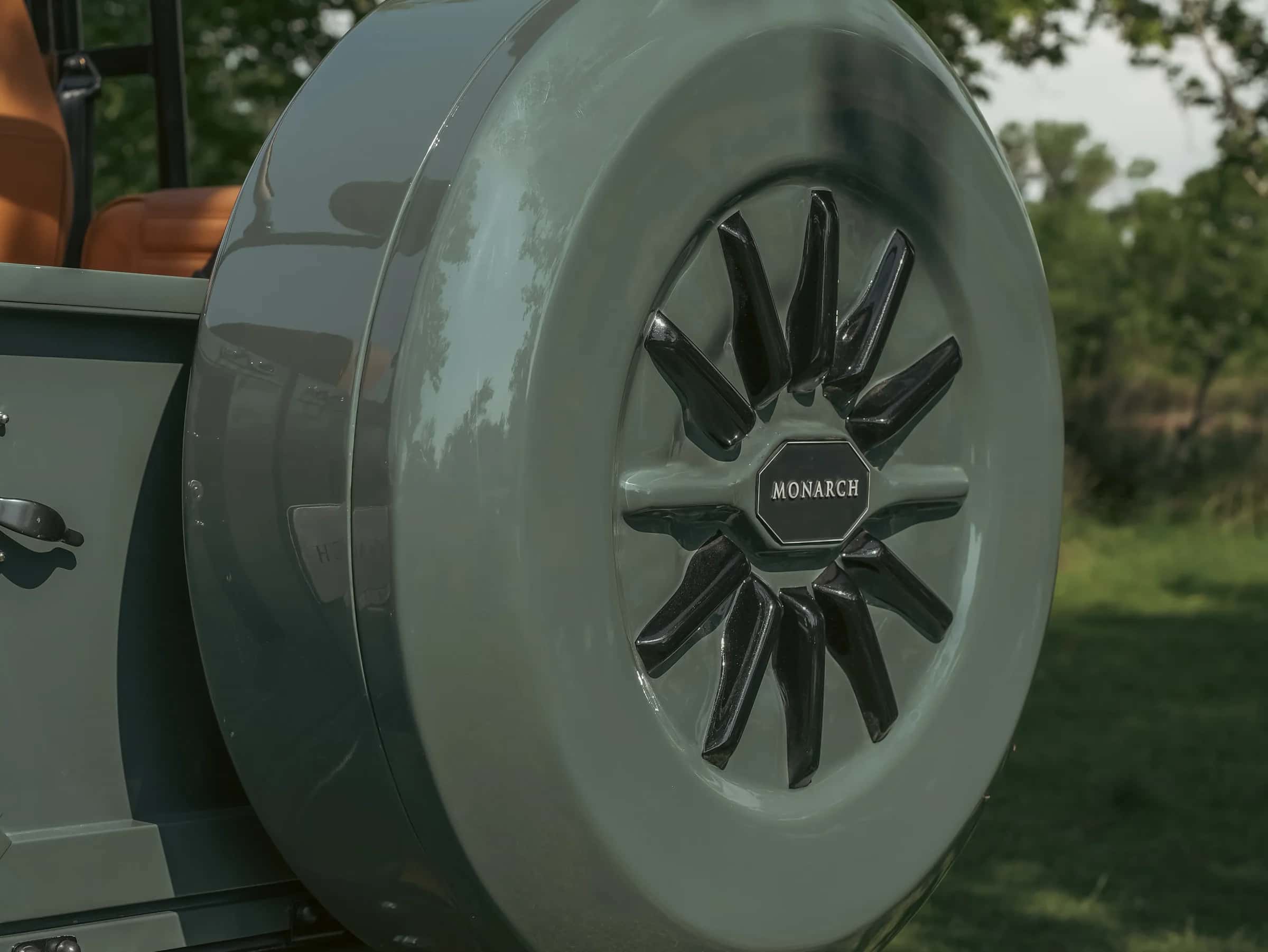 Close-up of a custom spare wheel on a Monarch Defender with a sleek design