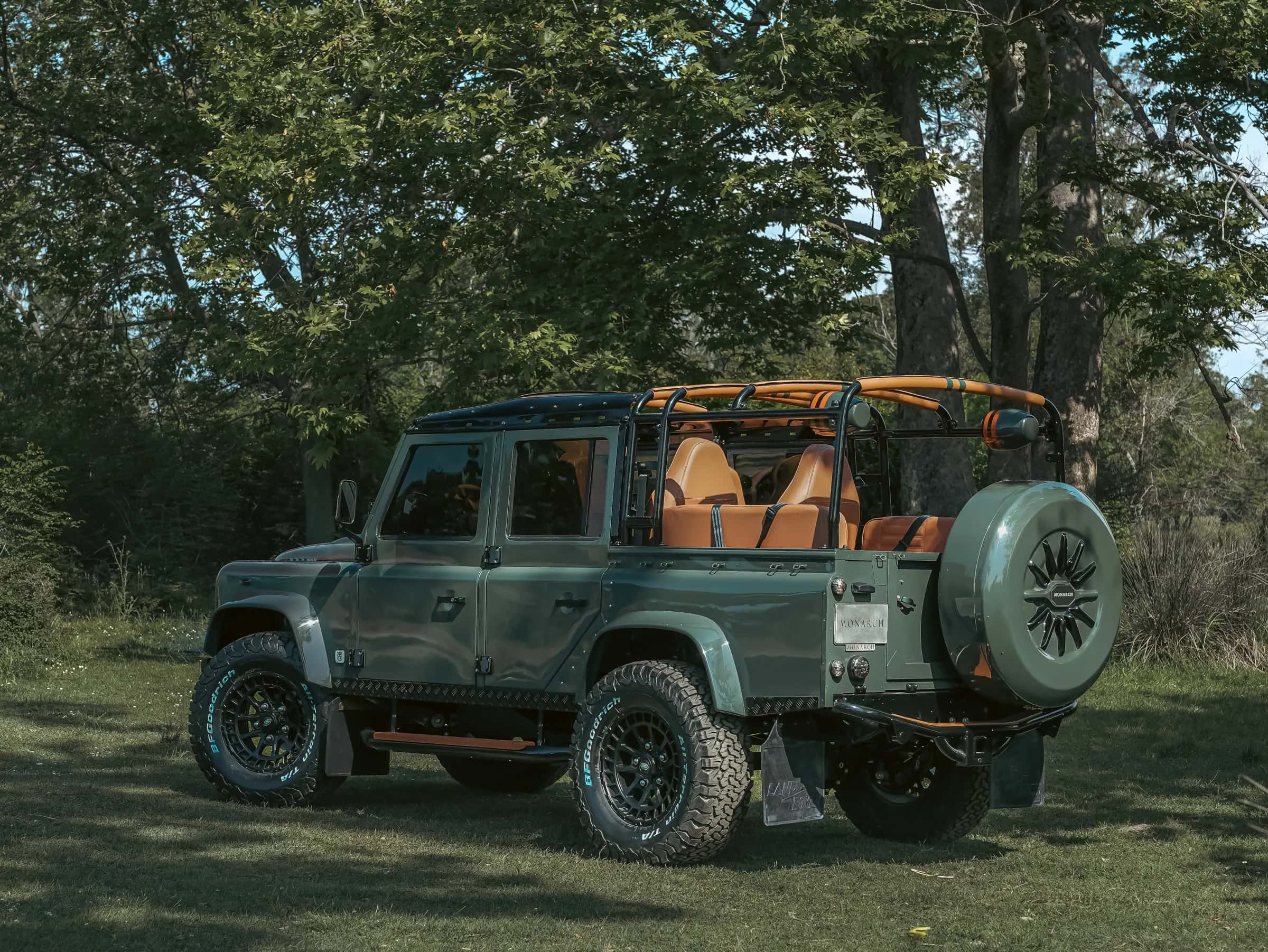 Custom Land Rover Defender in green with tan interior and off-road tires