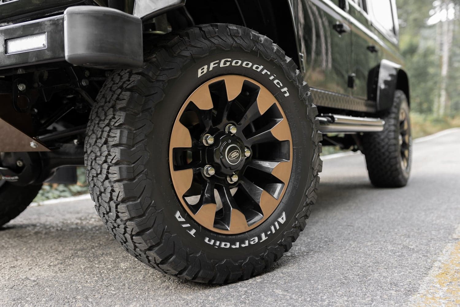Close-up of a bespoke Land Rover Defender wheel with black and bronze finish