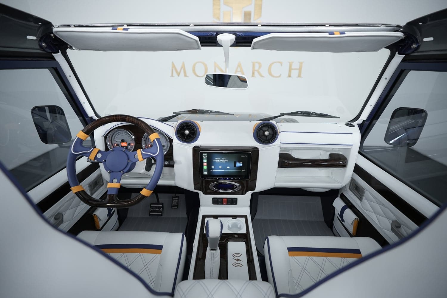 Luxurious interior of a custom Land Rover Defender featuring premium materials and modern technology