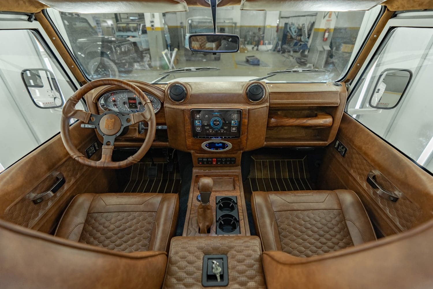 Interior view of a custom Land Rover Defender with premium leather upholstery and modern dashboard features