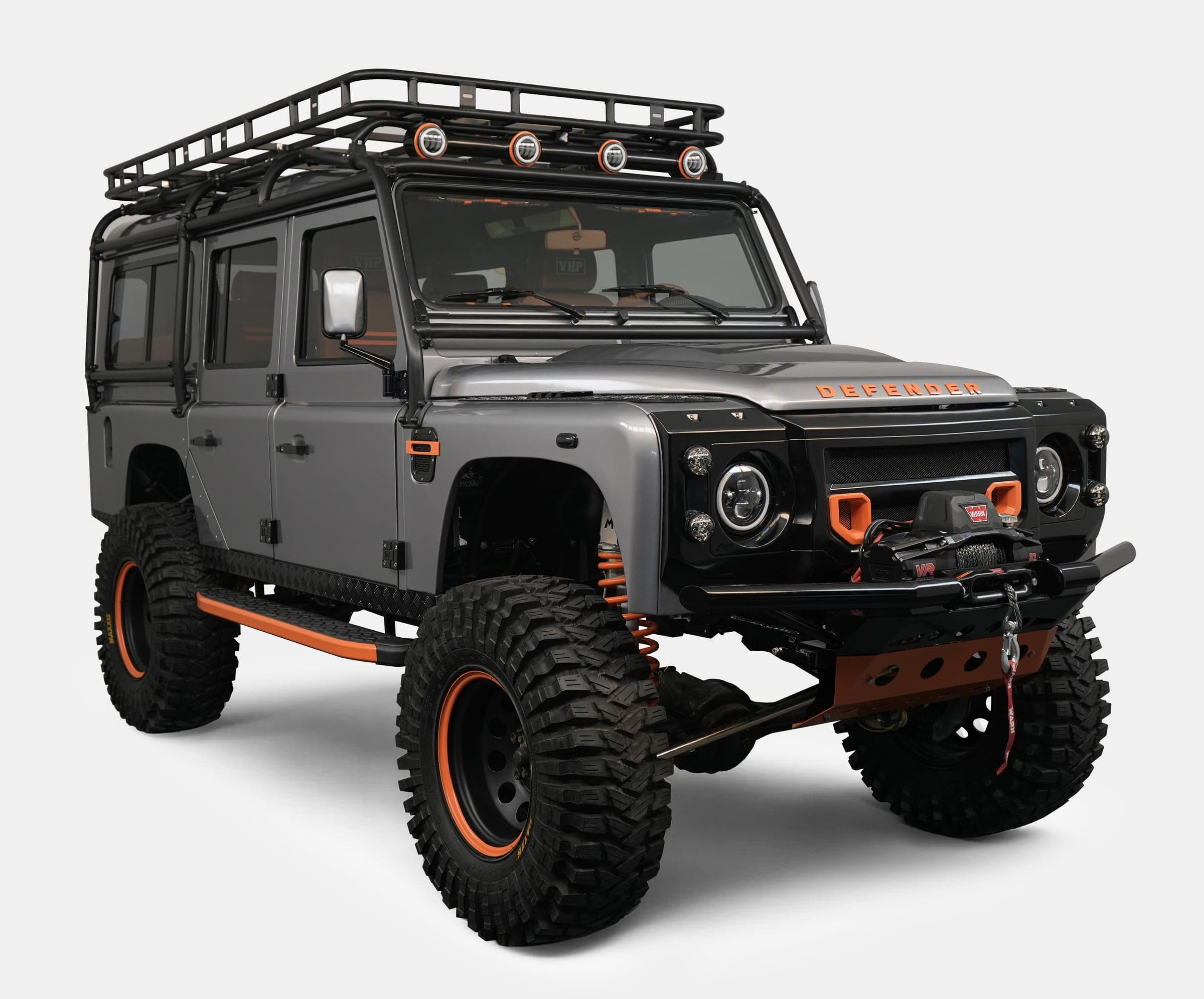 Custom Land Rover Defender in grey with orange accents and off-road tires