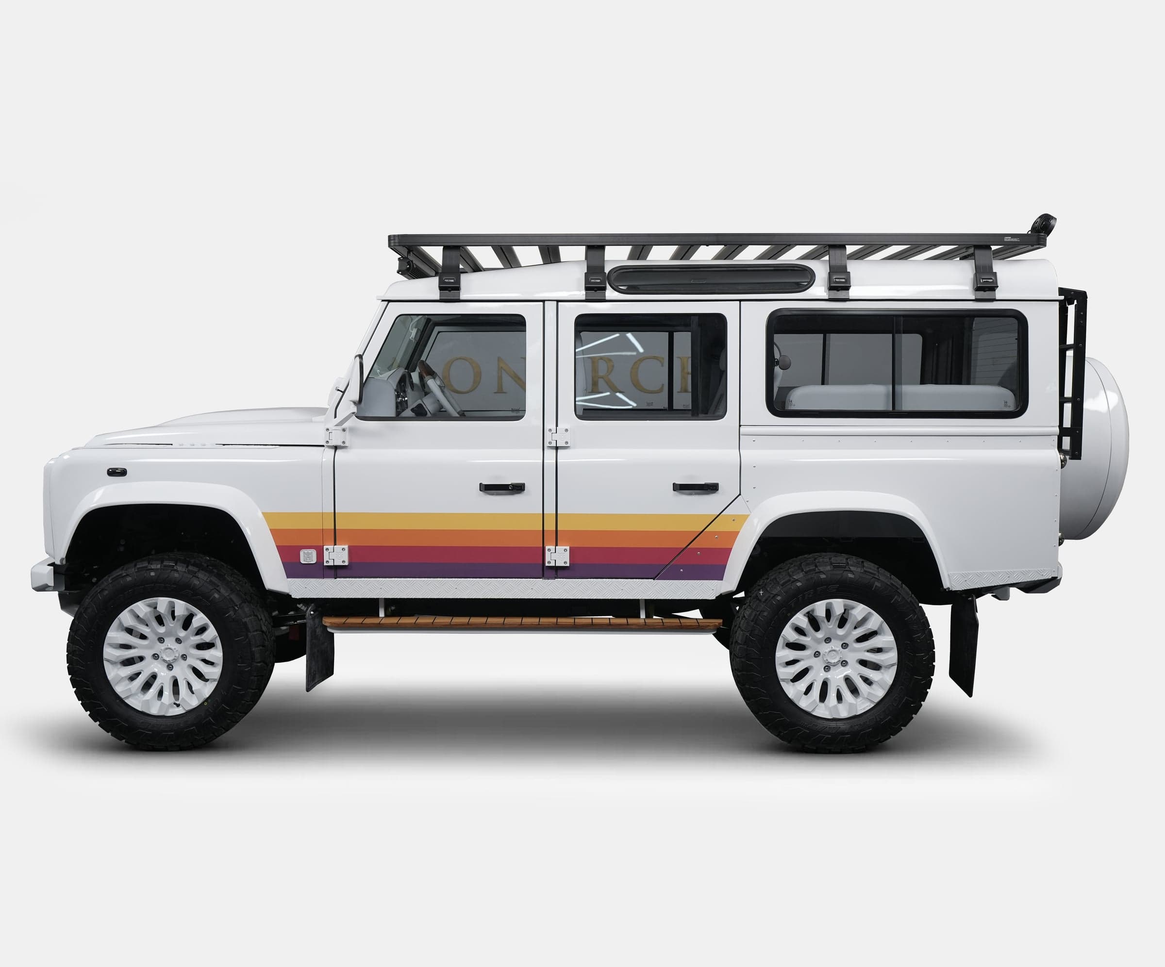 White custom Land Rover Defender with retro stripe design and roof rack