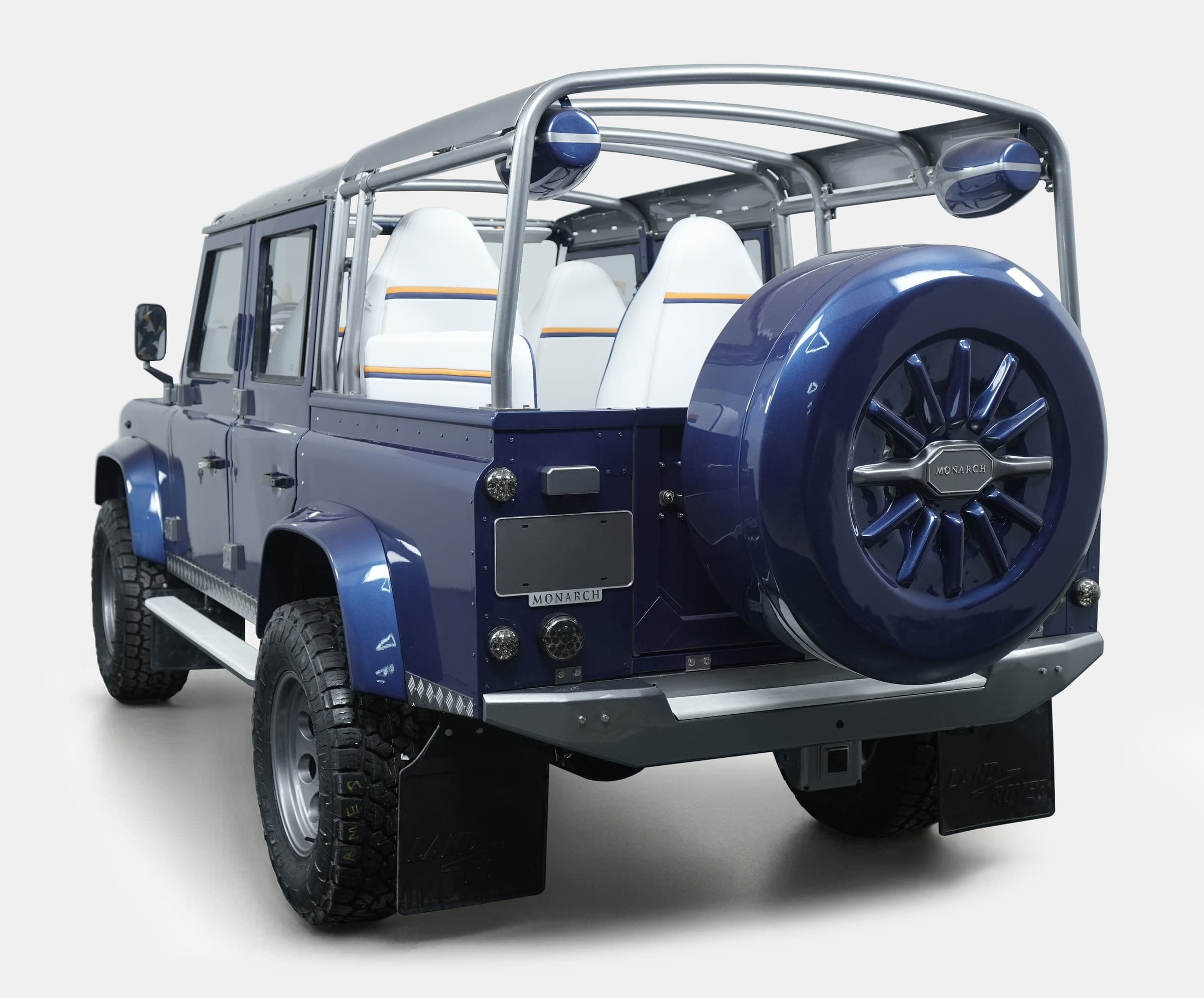Rear view of a bespoke Land Rover Defender with a blue finish and premium seating