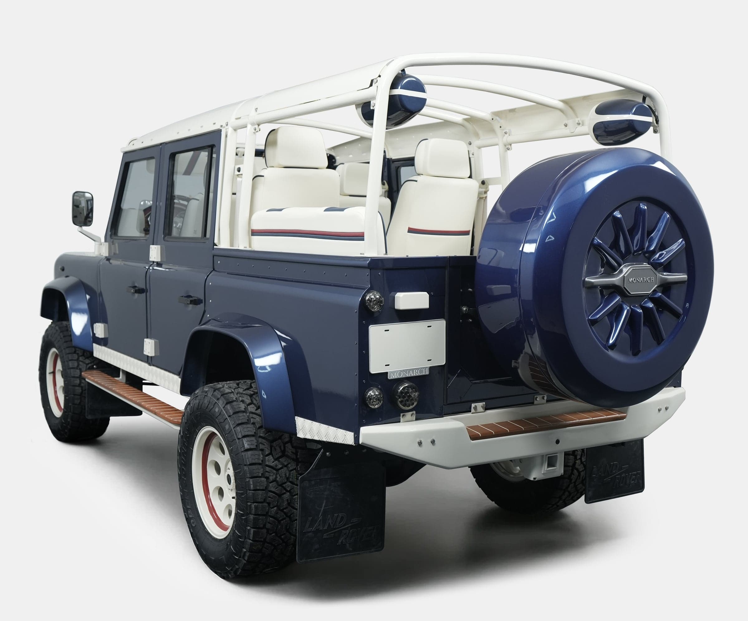 Custom Land Rover Defender in navy blue with white interior and off-road tires