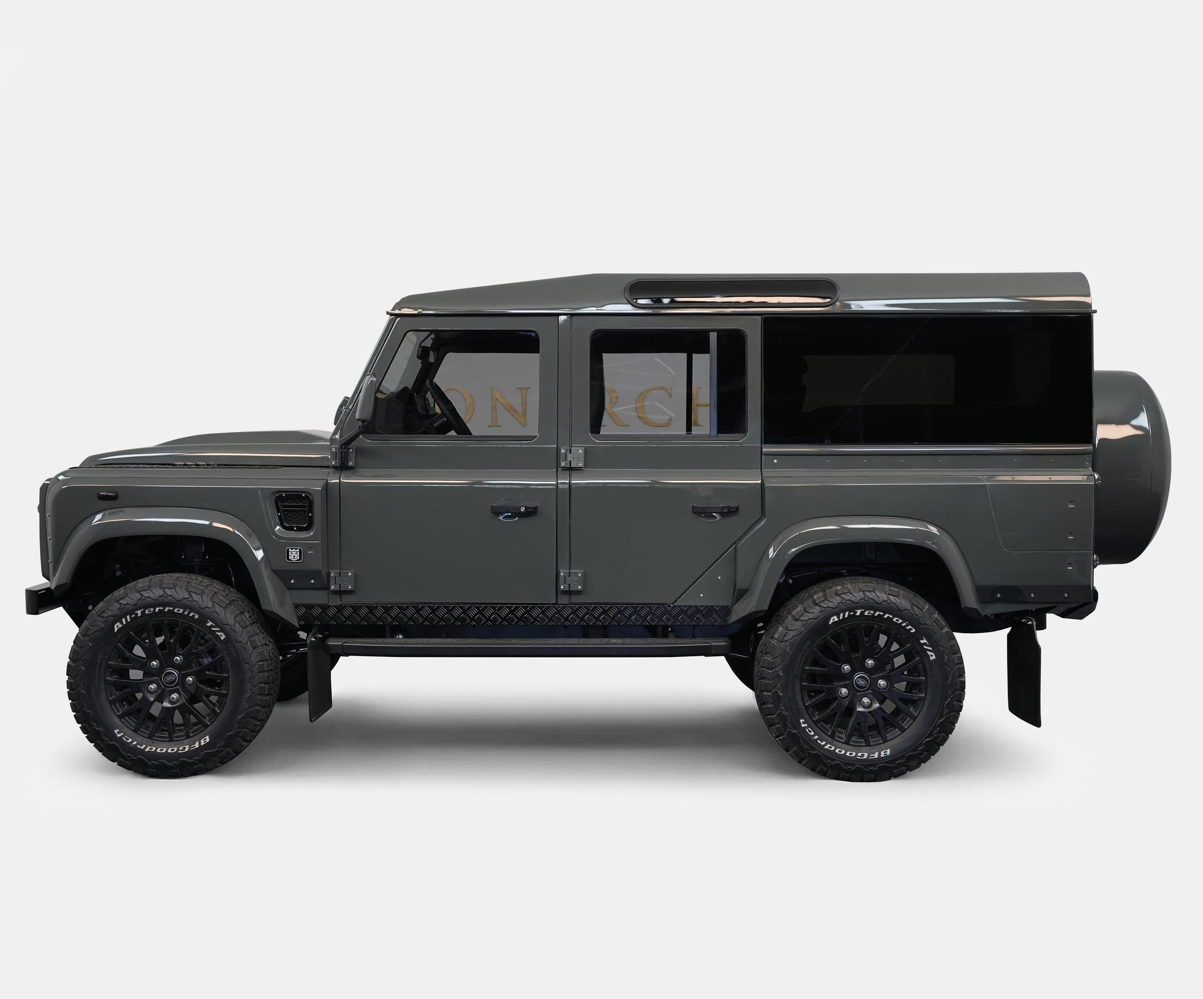 Side view of a custom Land Rover Defender in a sleek gray finish