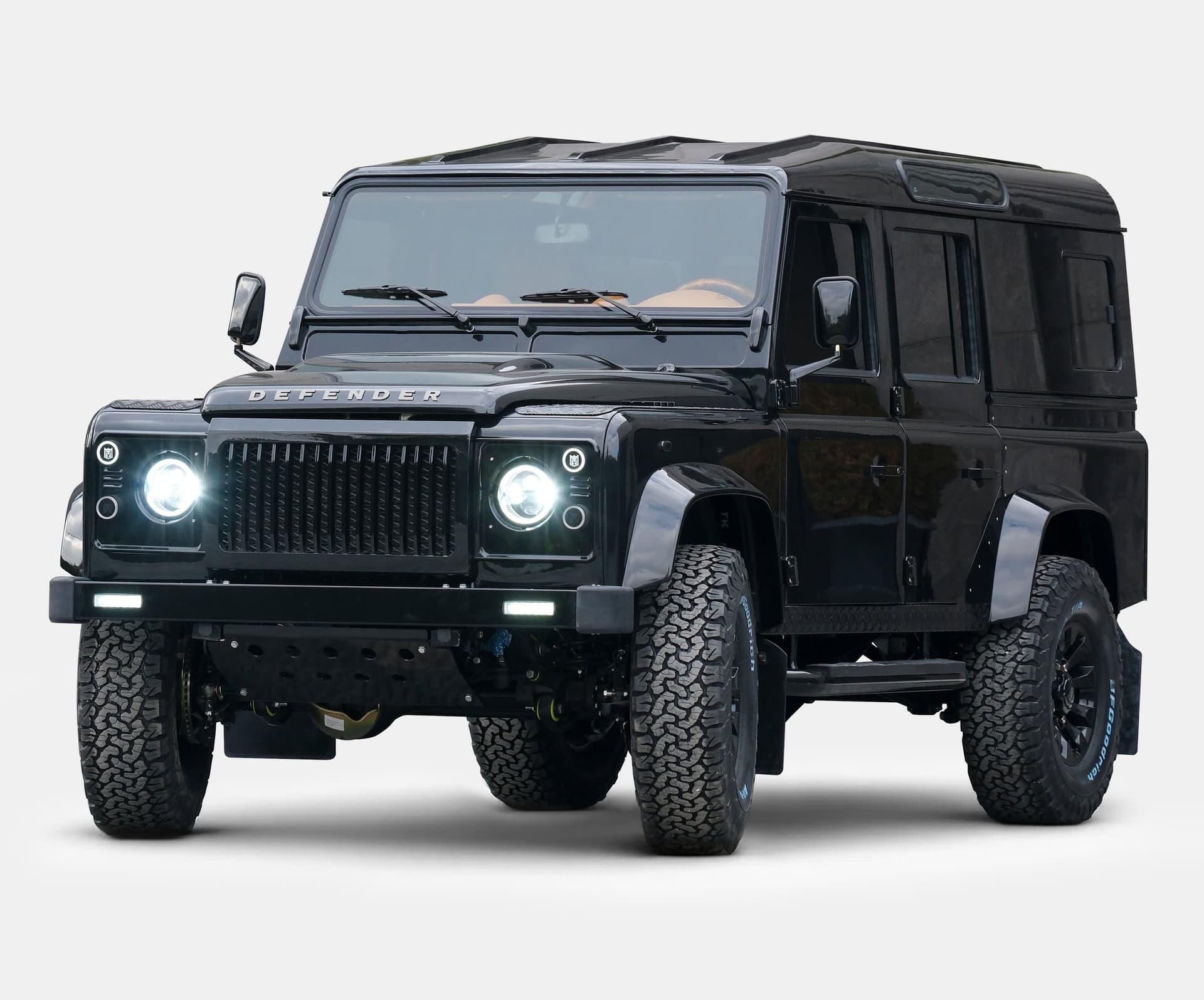 Front view of a luxury black Land Rover Defender with custom modifications