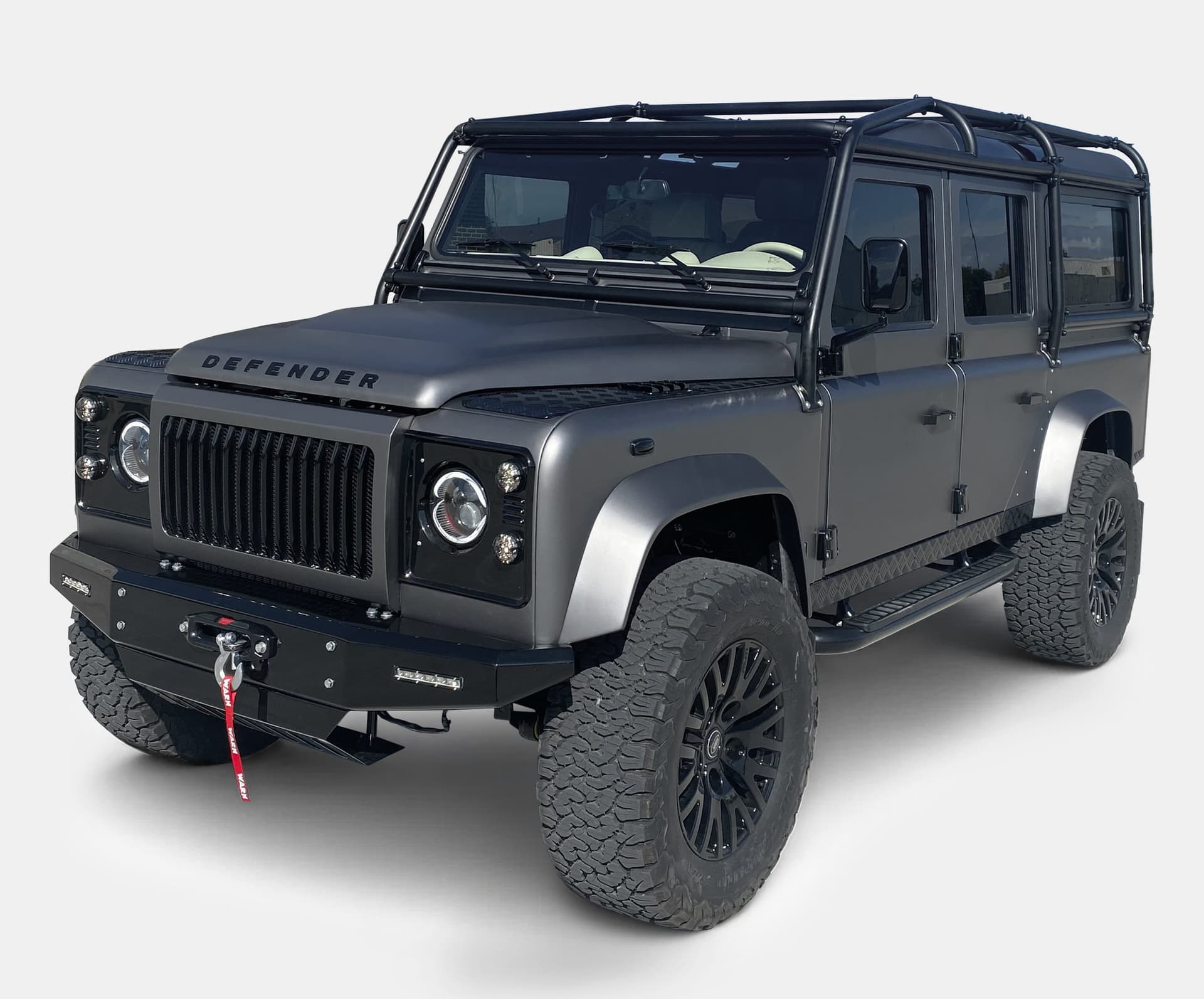 Custom Land Rover Defender with matte finish and rugged tires
