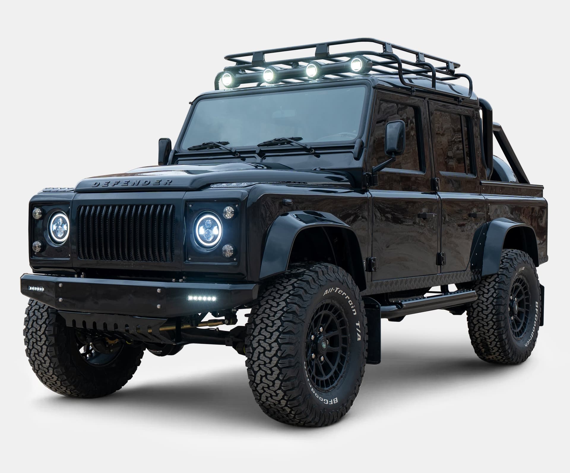 Front view of a custom black Land Rover Defender with off-road features