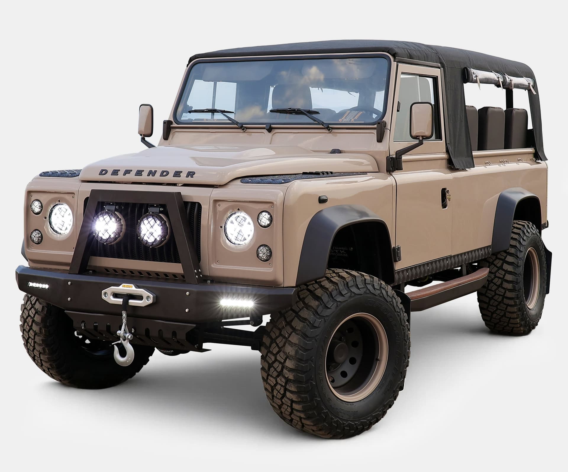Custom Land Rover Defender featuring a beige exterior and off-road capabilities