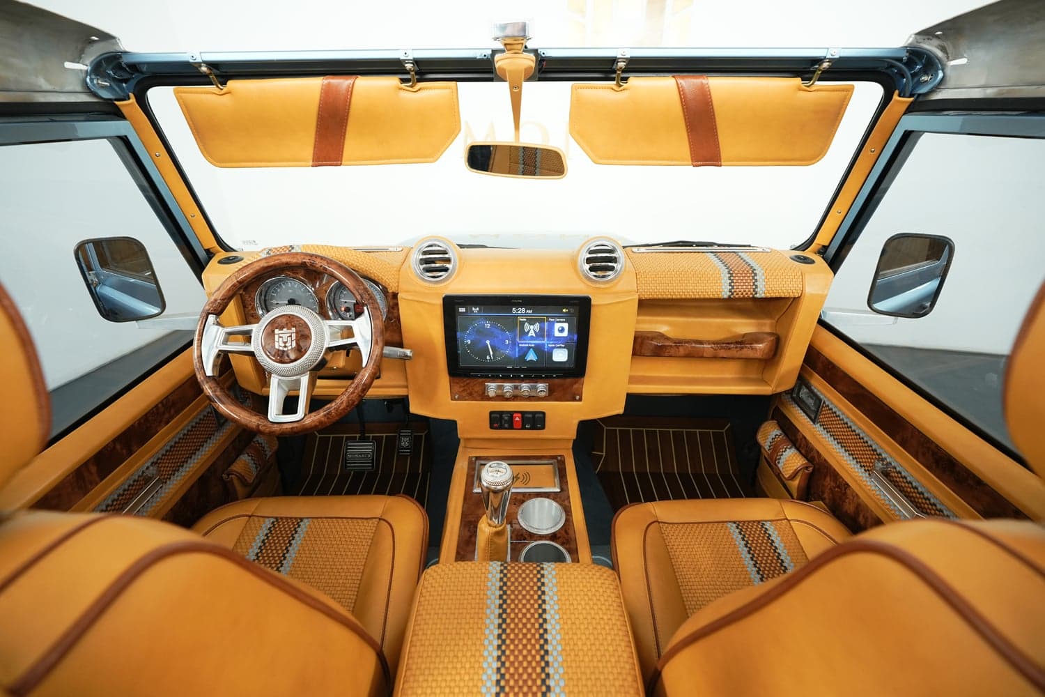 Bespoke Land Rover Defender interior featuring premium tan leather and wood accents