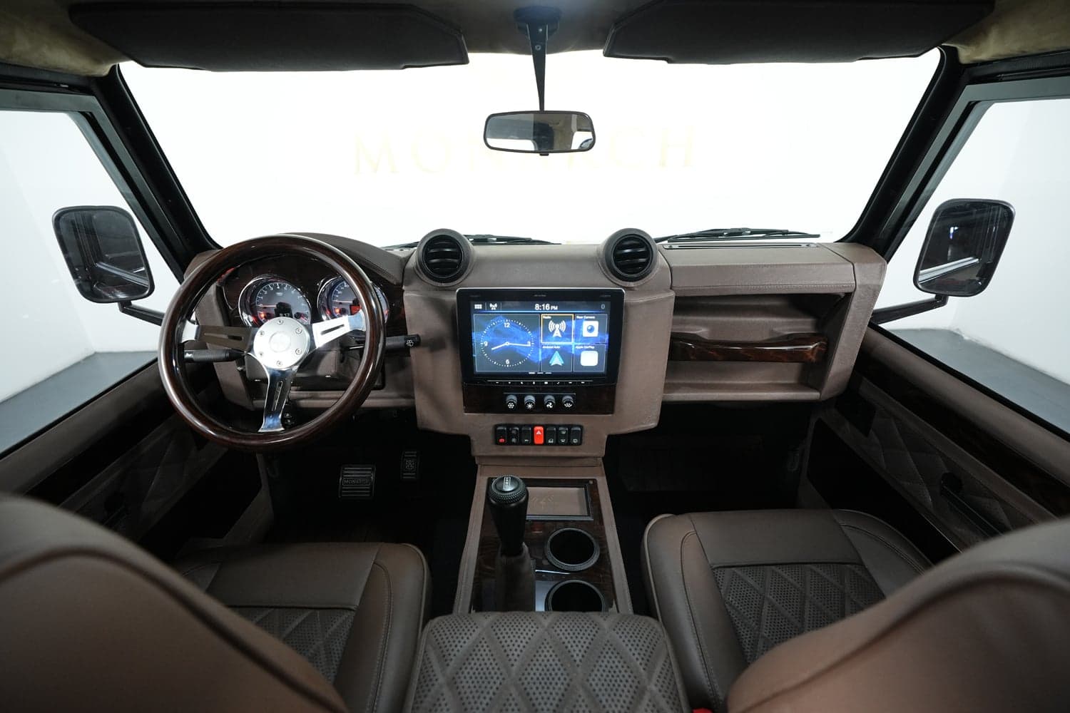 Interior view of a luxury custom Land Rover Defender showcasing a stylish dashboard and seating