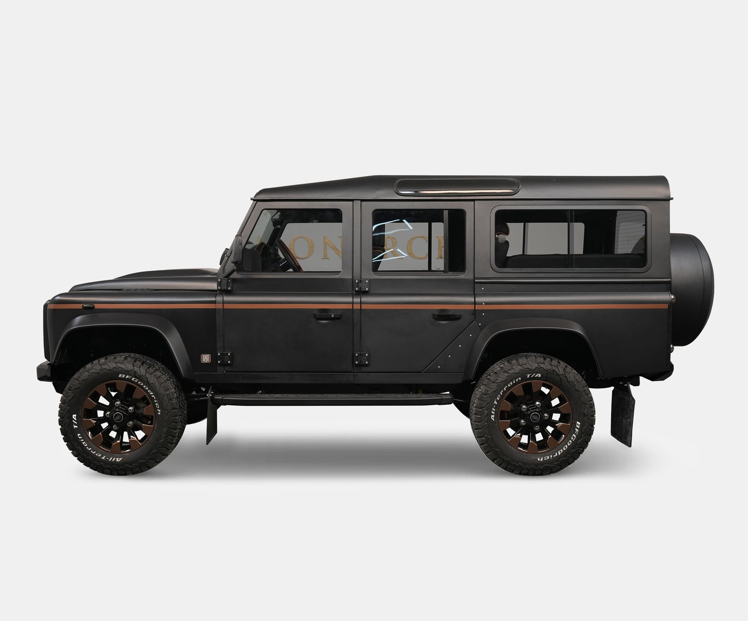 Custom Land Rover Defender in matte black with bronze wheels