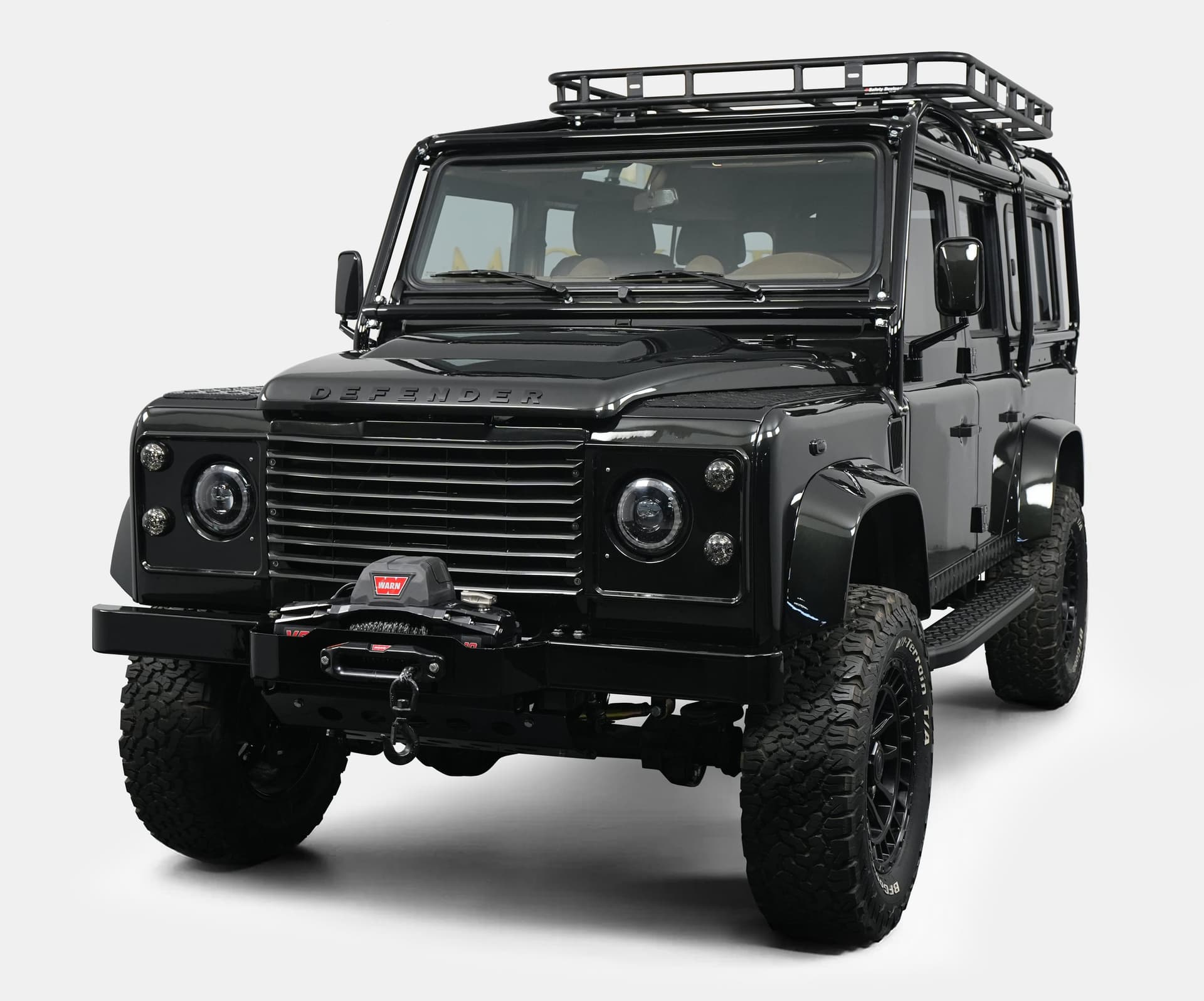 Front view of a luxury custom Land Rover Defender with a black exterior and off-road features