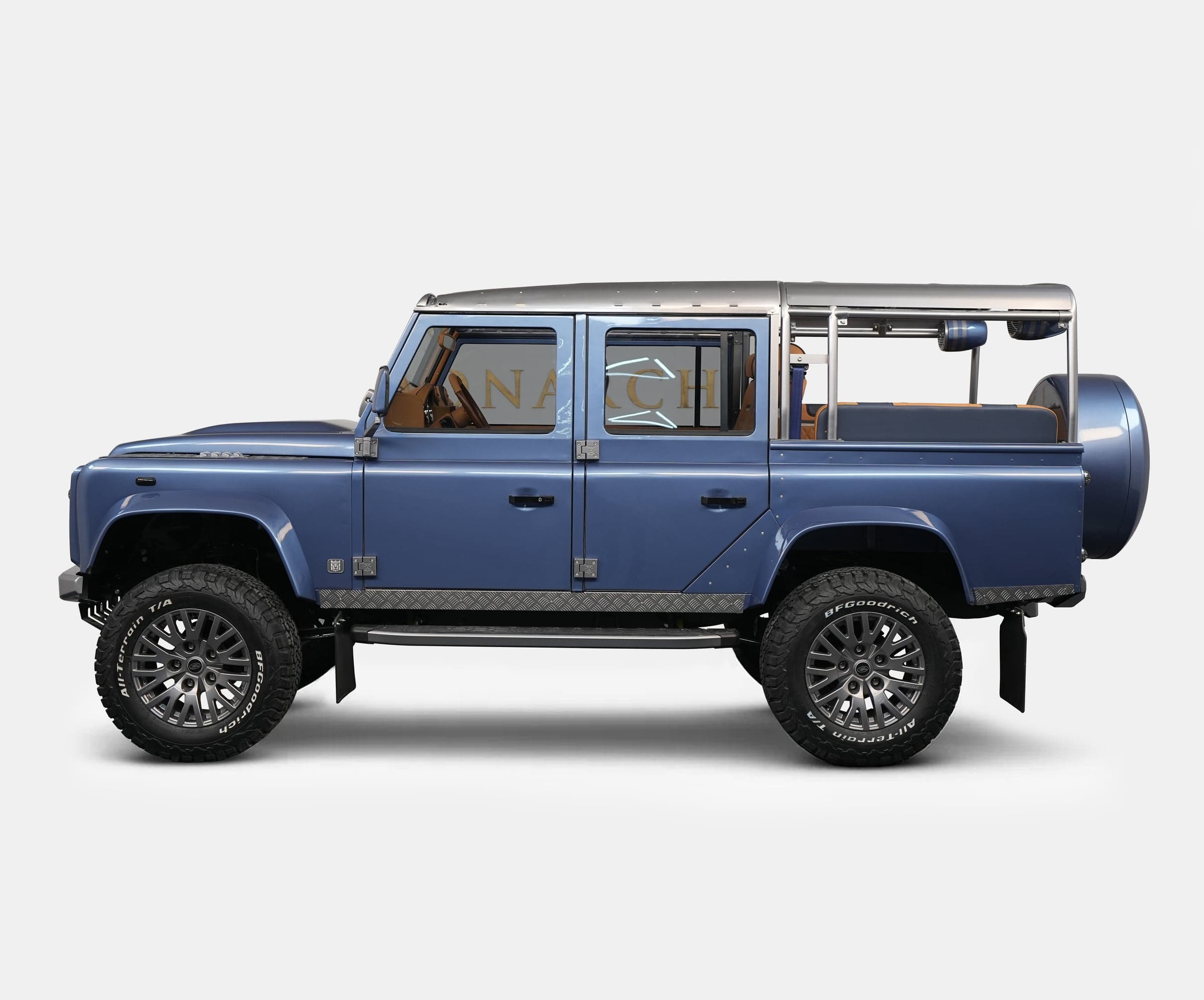 Side view of a bespoke blue Land Rover Defender with luxury modifications