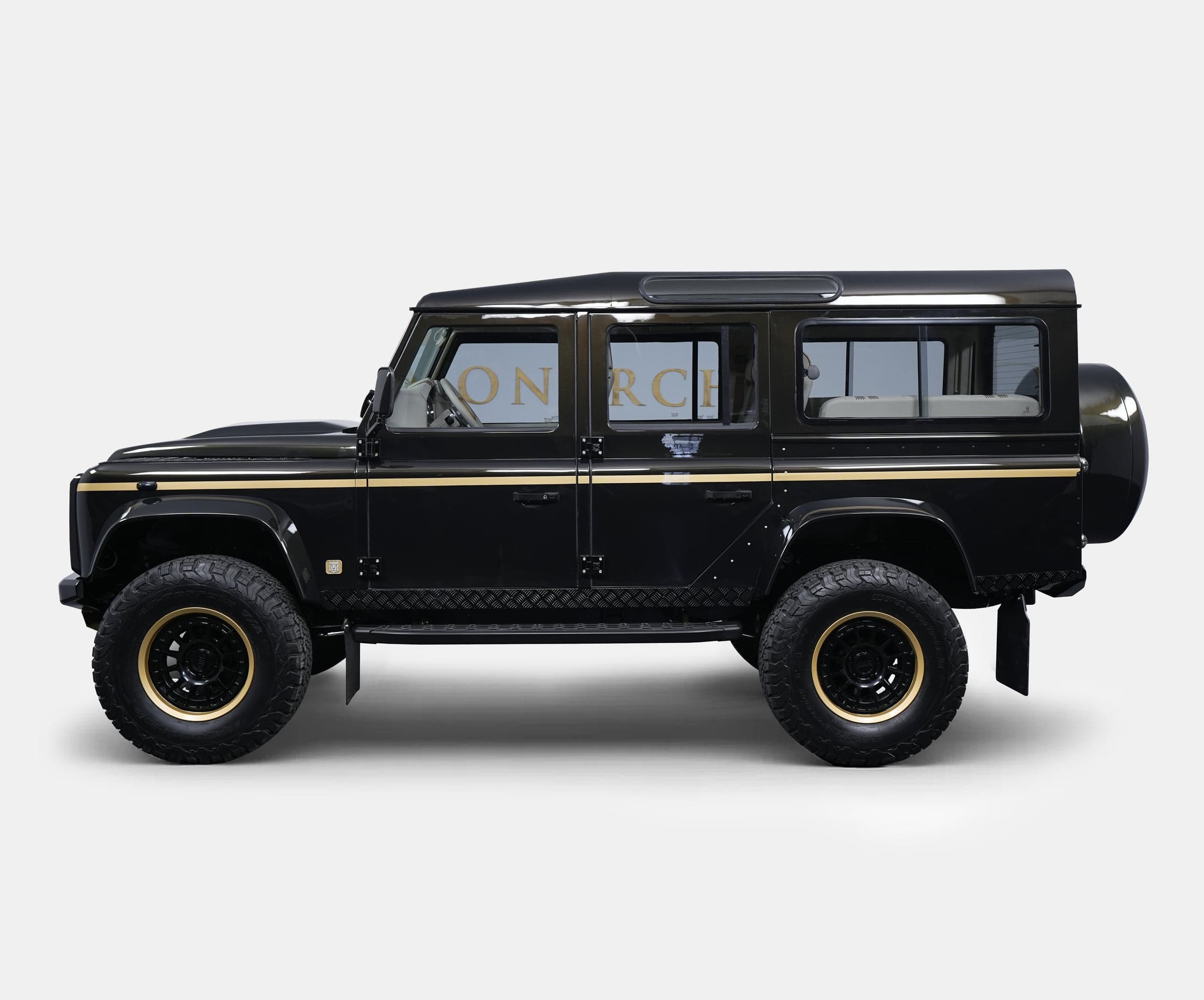 Luxury custom Land Rover Defender in black with gold accents