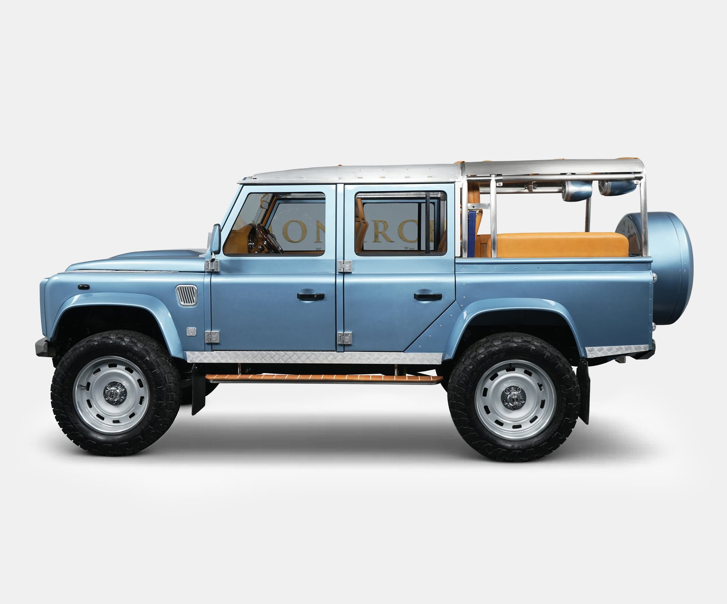 Custom blue Land Rover Defender with tan interior and chrome accents