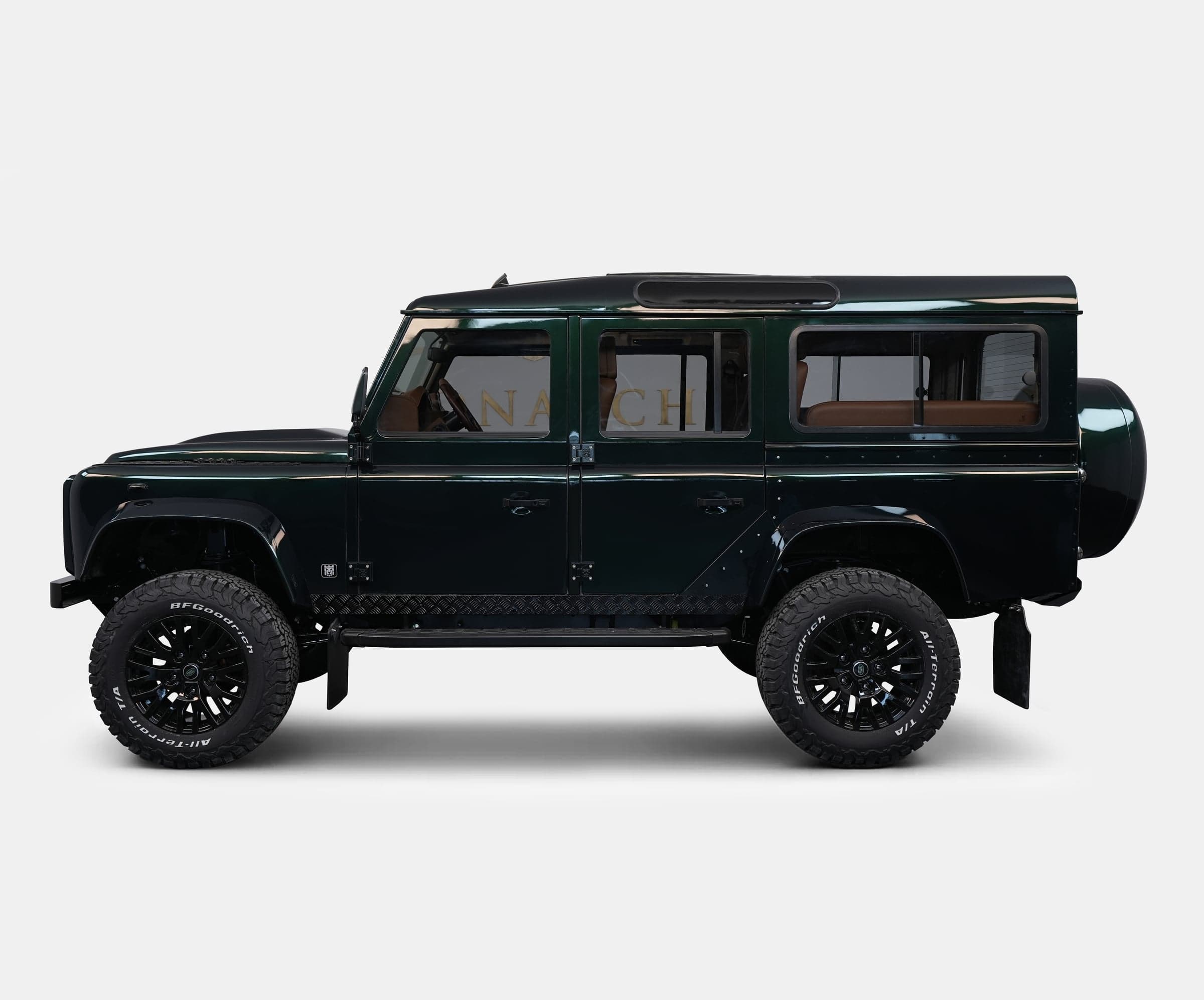 Bespoke Land Rover Defender in dark green with black wheels
