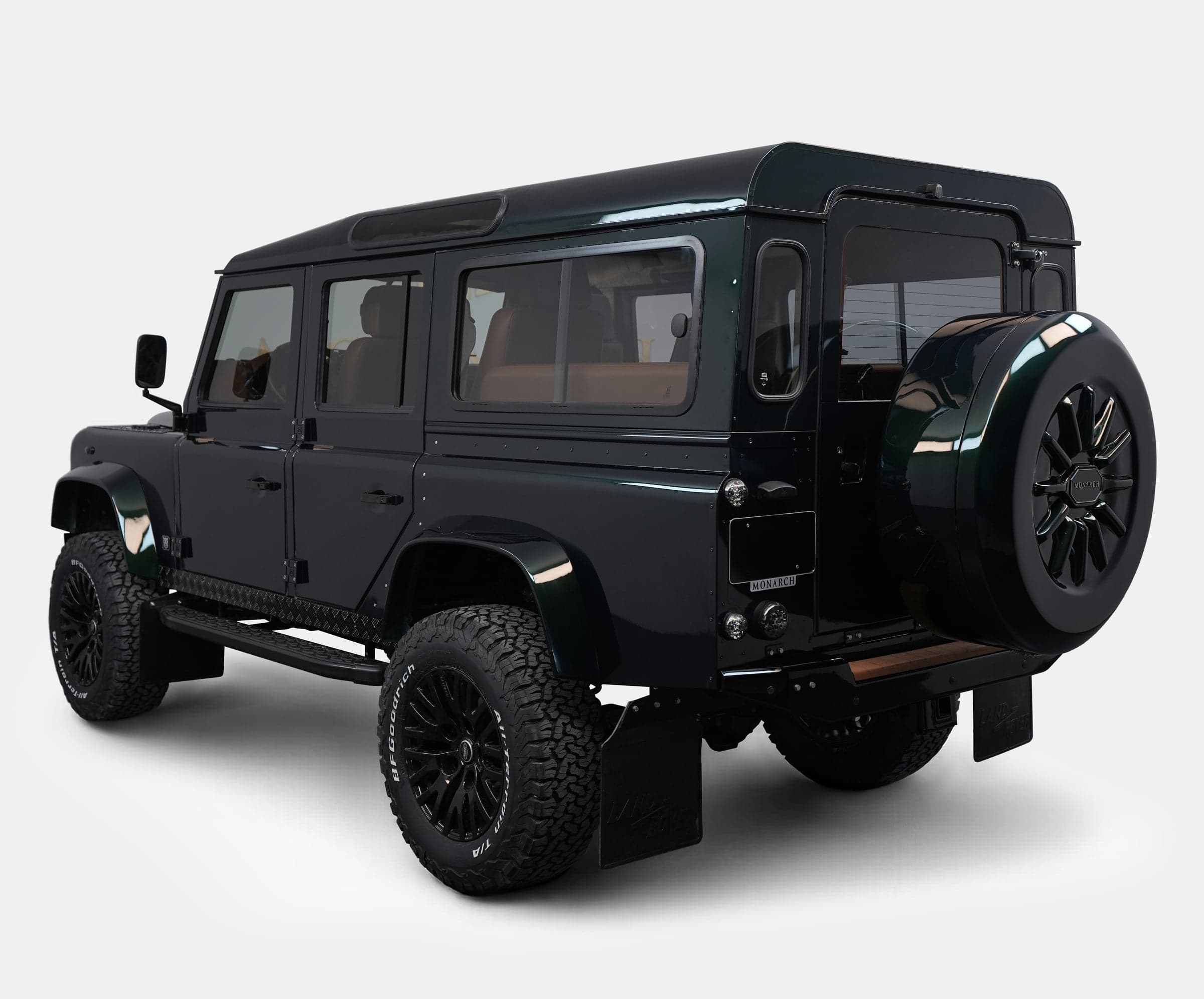 Custom Land Rover Defender in dark green finish with off-road tires