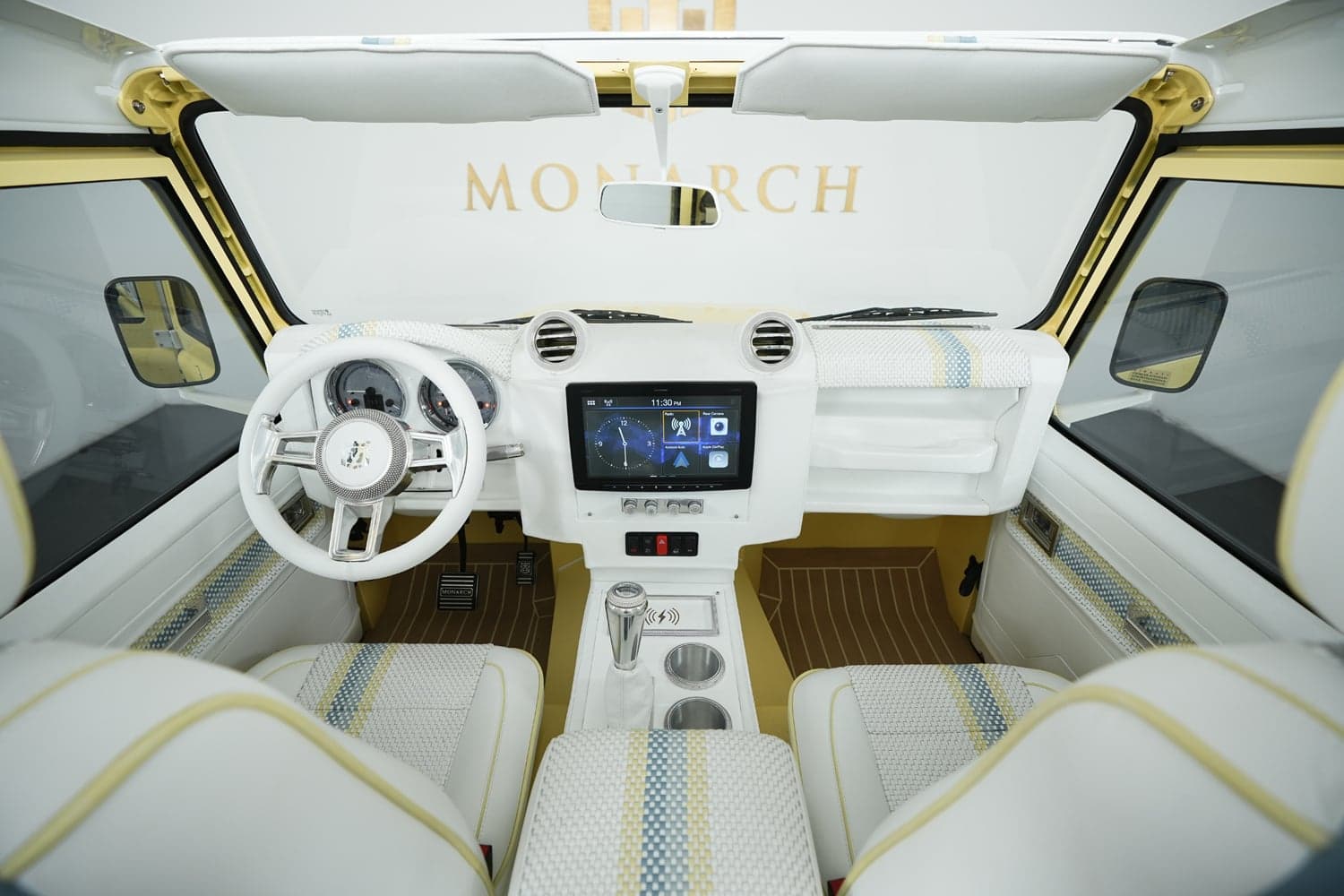 Interior of a custom Land Rover Defender featuring white and yellow upholstery