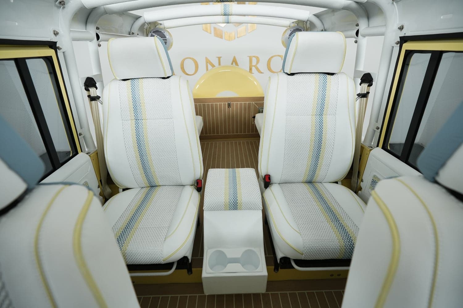 Luxury interior of a custom Land Rover Defender with white and blue patterned seats