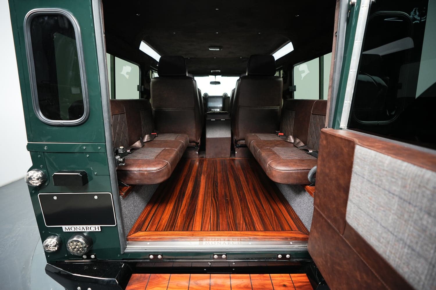 Interior view of a bespoke Land Rover Defender with premium leather seating and wooden flooring