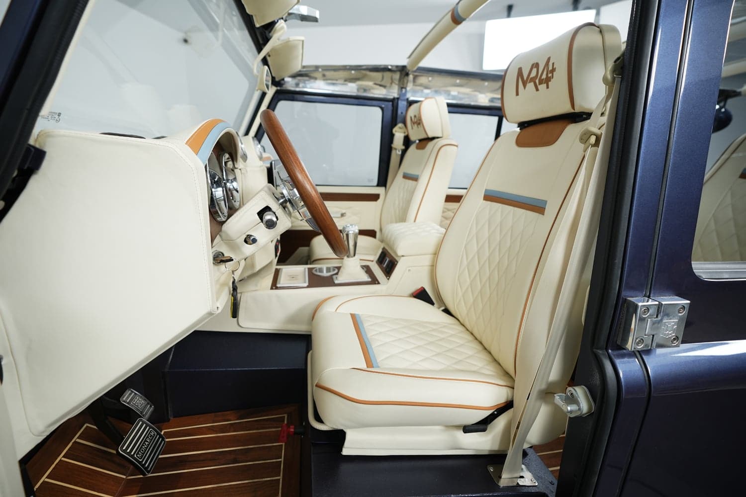 Interior of a bespoke Land Rover Defender featuring premium leather seats and a stylish dashboard
