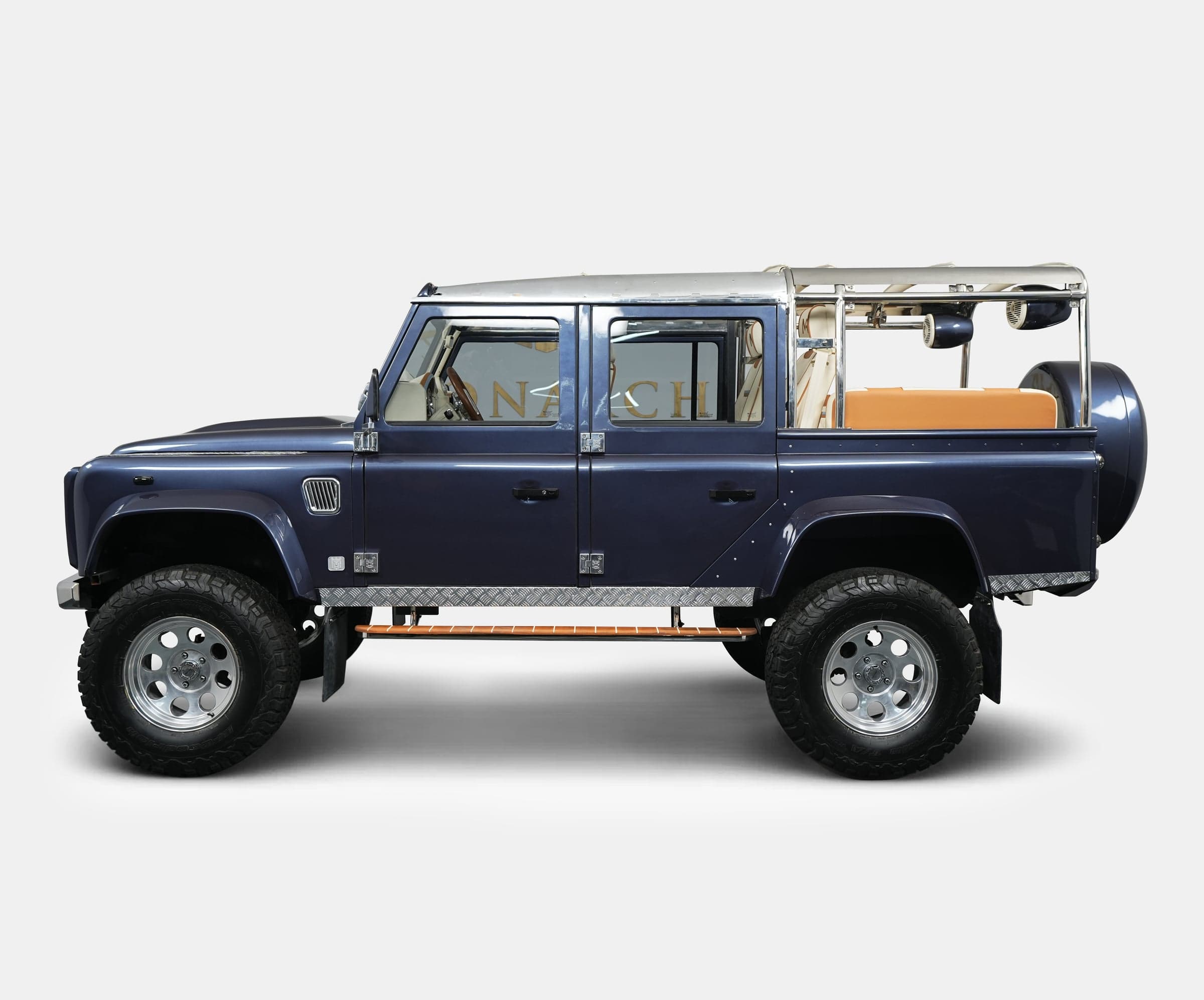 Custom Land Rover Defender in dark blue with chrome accents