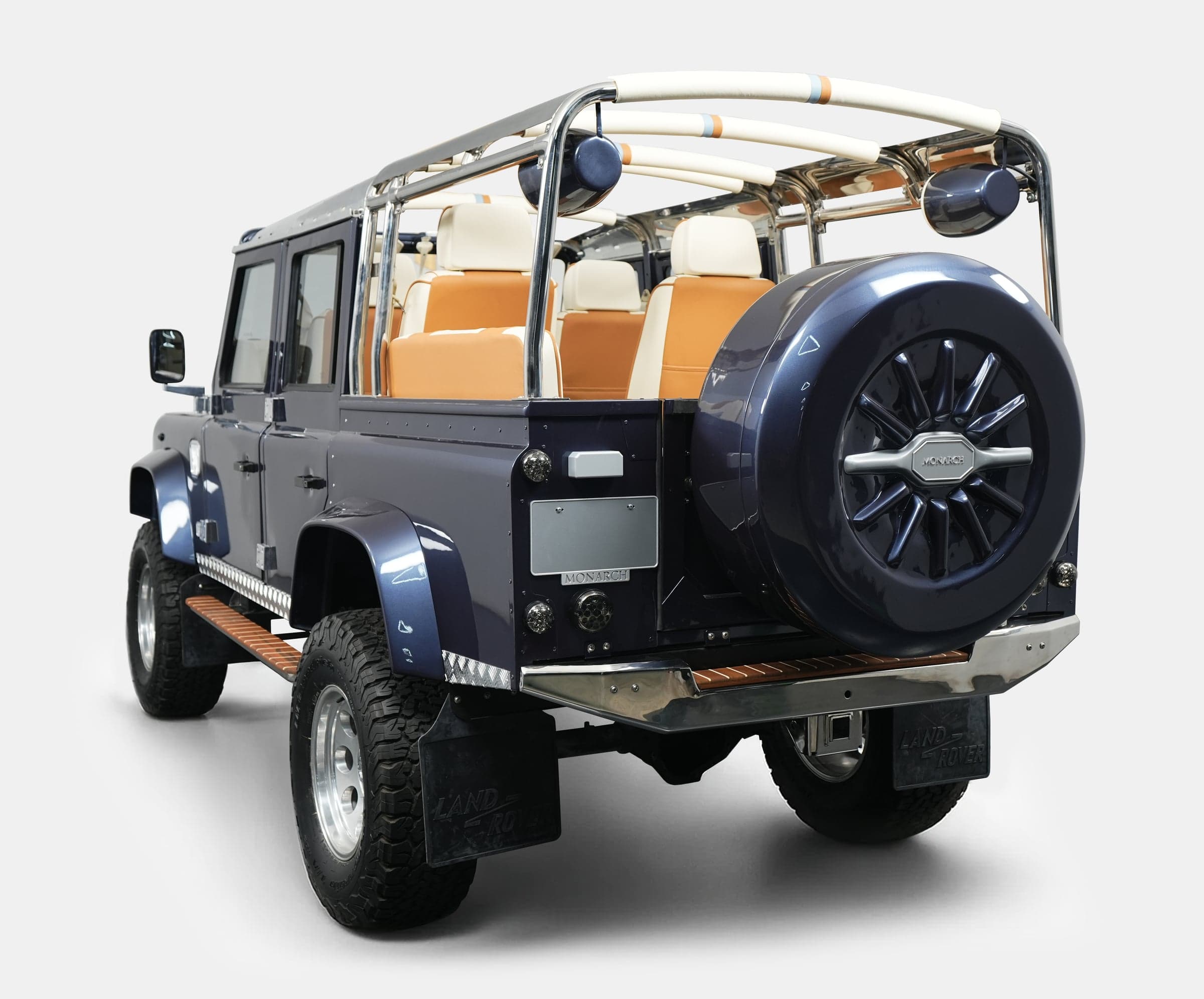 Custom Land Rover Defender in deep blue with beige interior and chrome accents