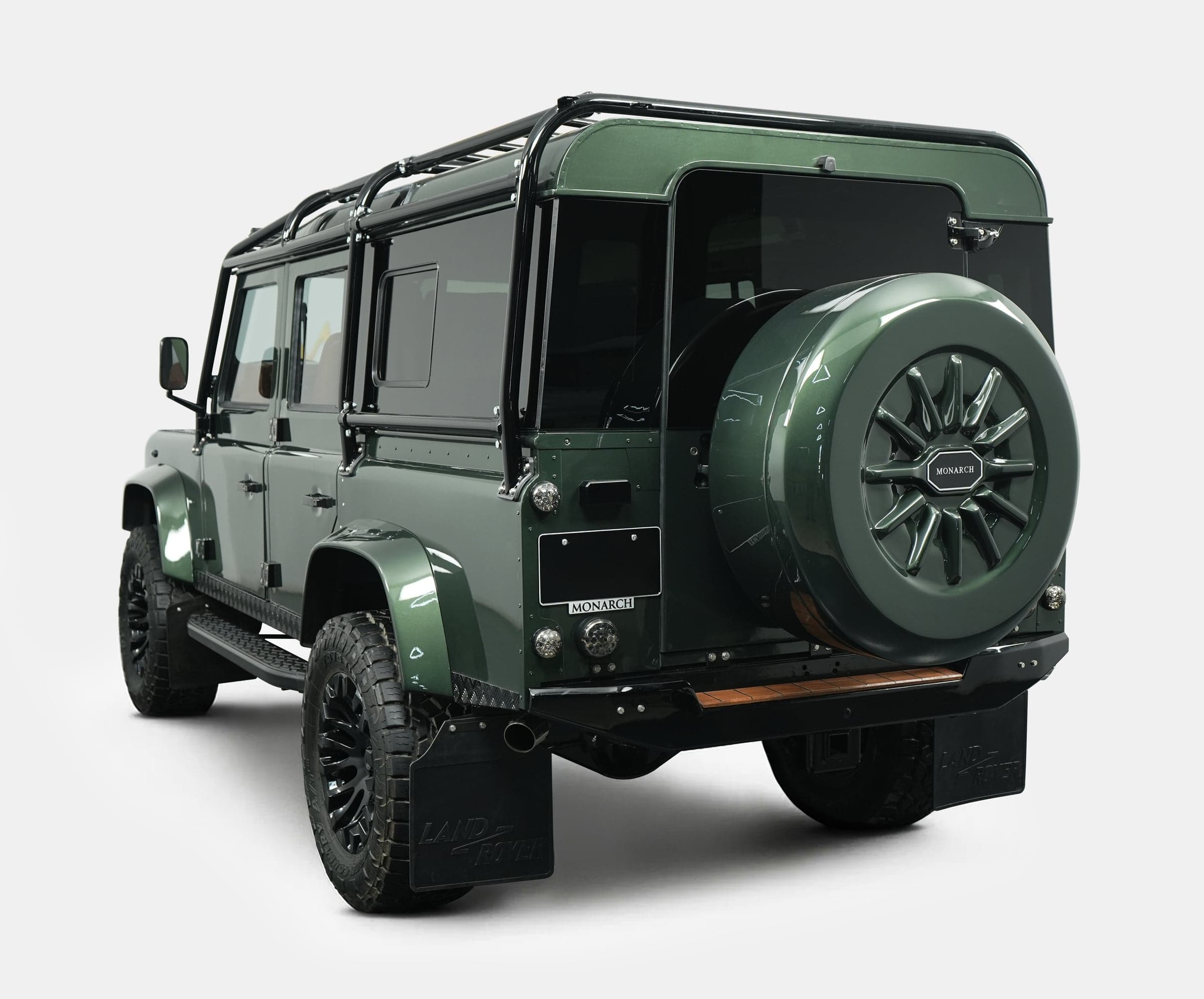 Rear view of a bespoke Land Rover Defender in deep green with custom features