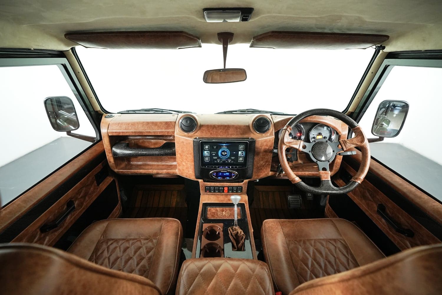 Bespoke Land Rover Defender interior featuring premium leather seats and advanced dashboard