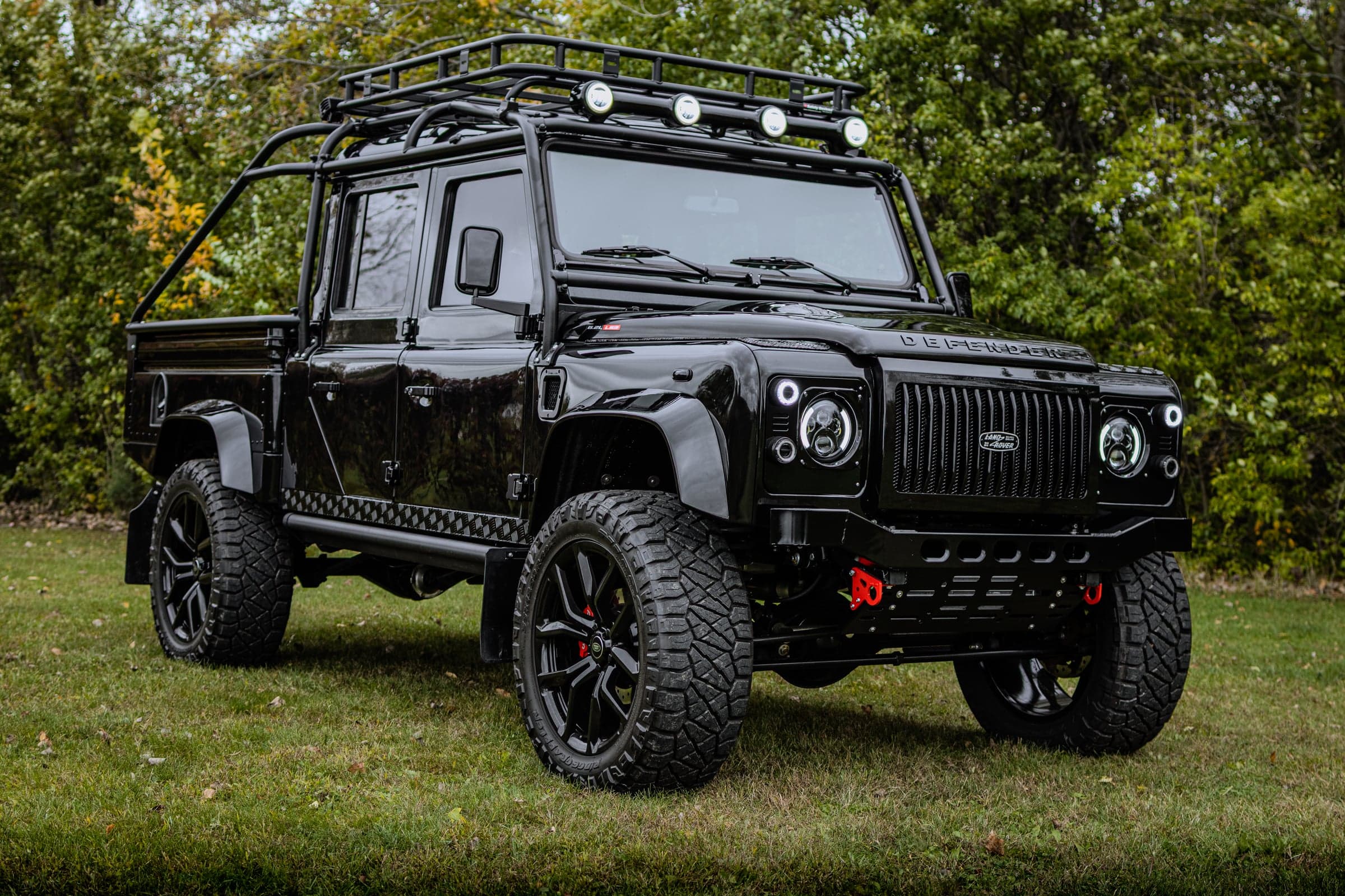 Custom black Land Rover Defender with off-road modifications