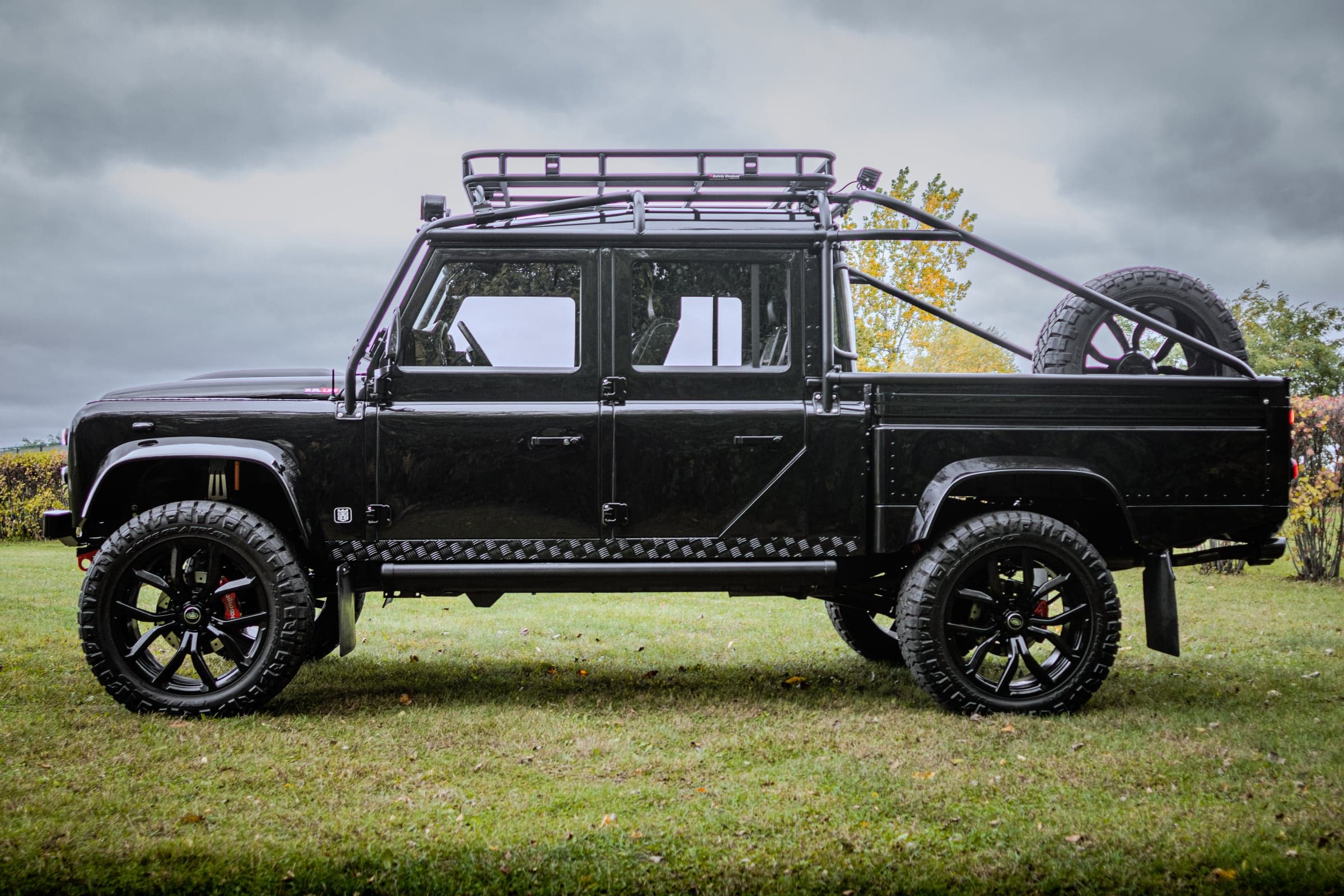Bespoke black Land Rover Defender with custom wheels and off-road accessories