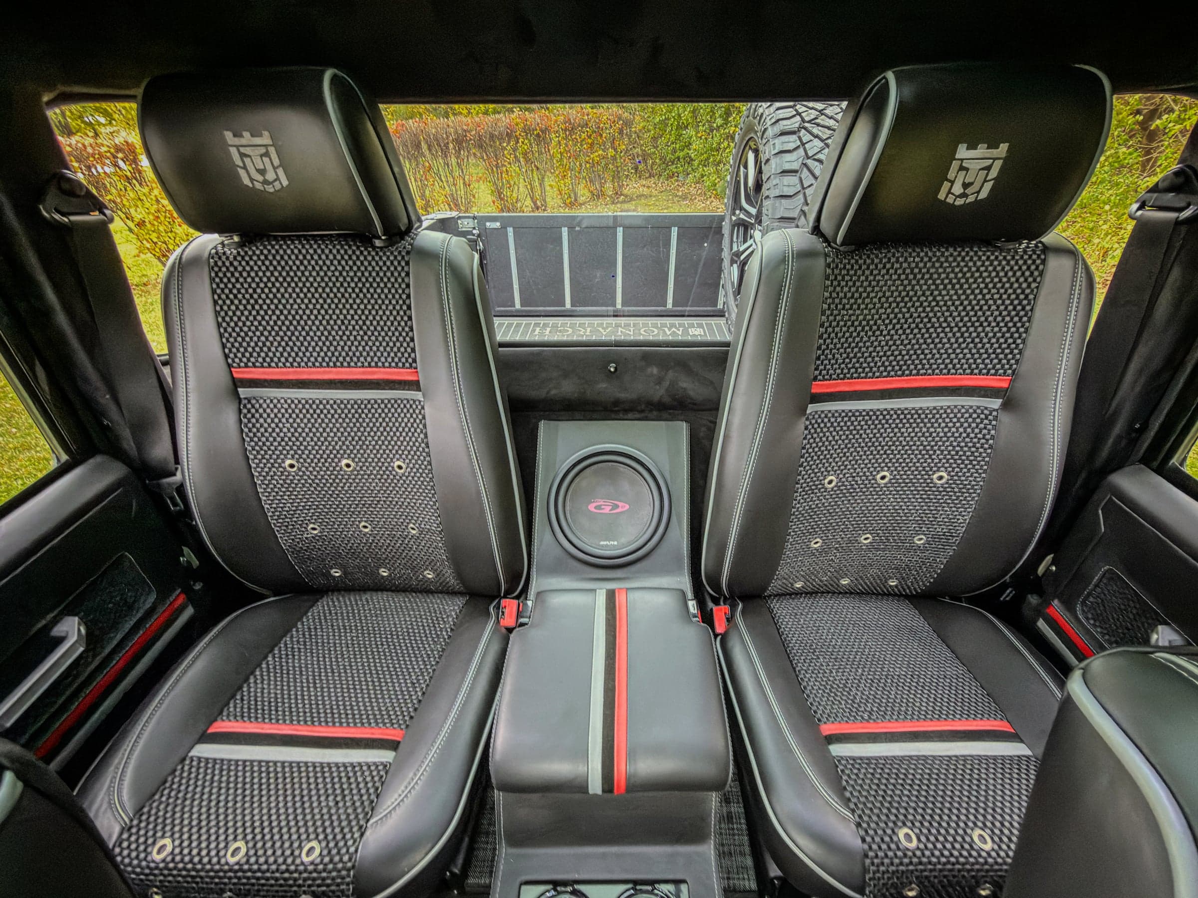 Interior view of a luxury custom Land Rover Defender with black and red upholstery