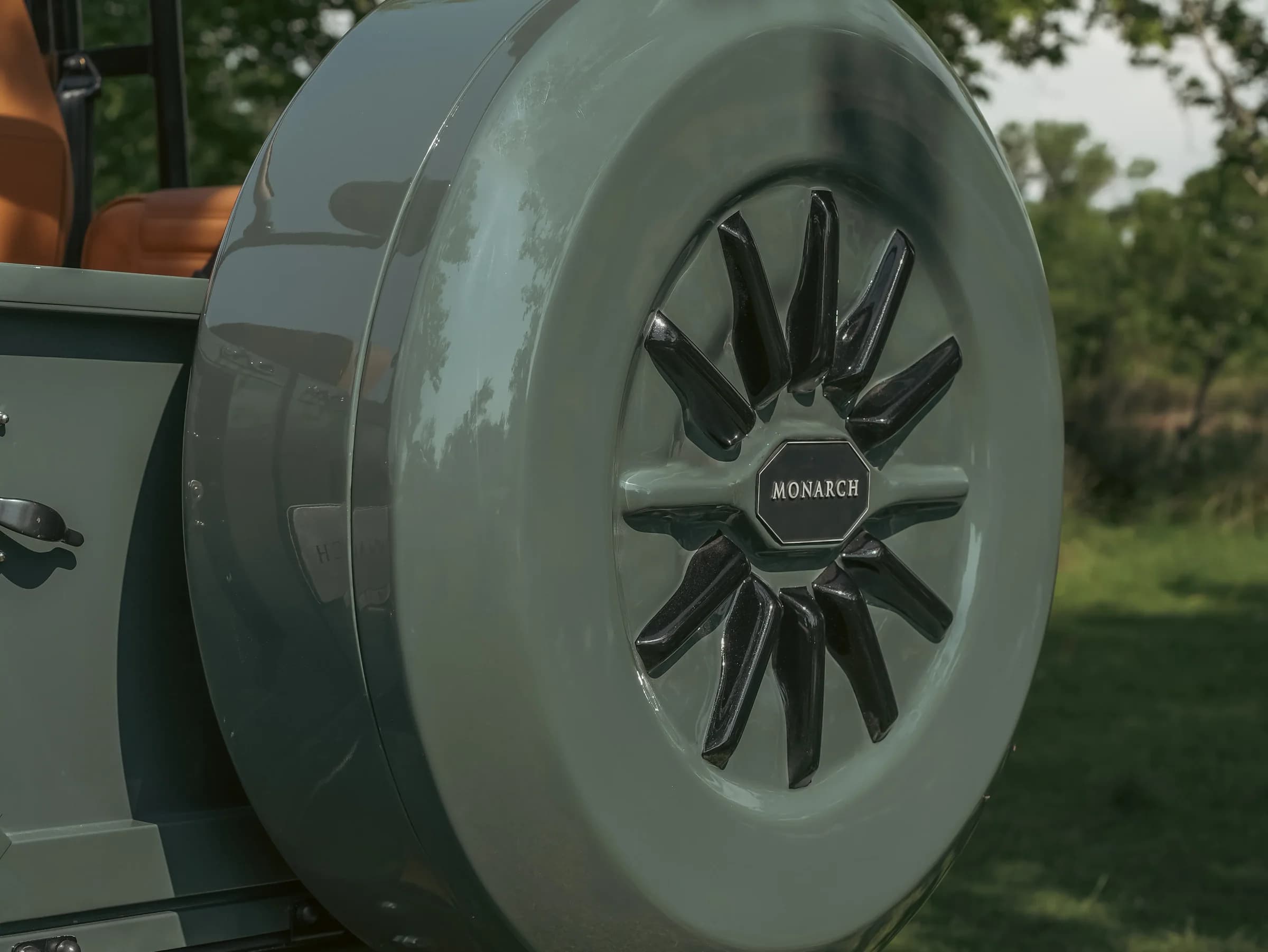 Close-up of a custom spare wheel on a Monarch Defender with a sleek design