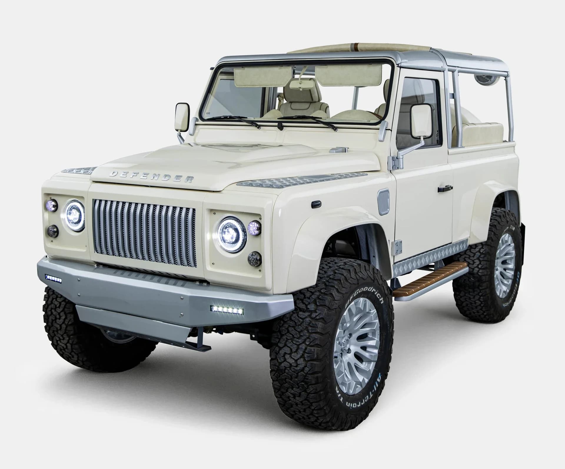 Restored vintage Land Rover Defender 90 in Alpine White with soft top