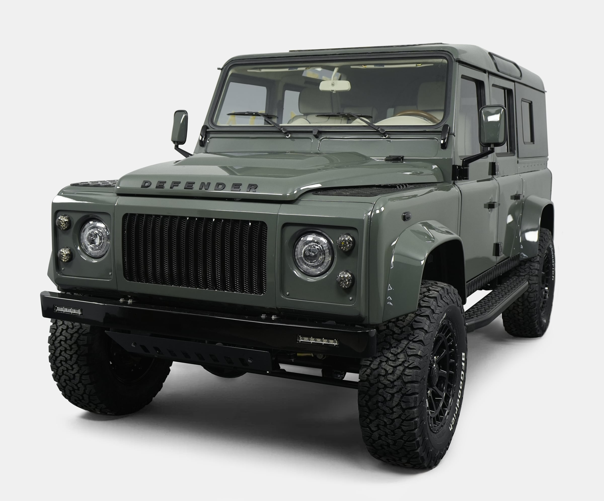 Front view of a custom Land Rover Defender in green color