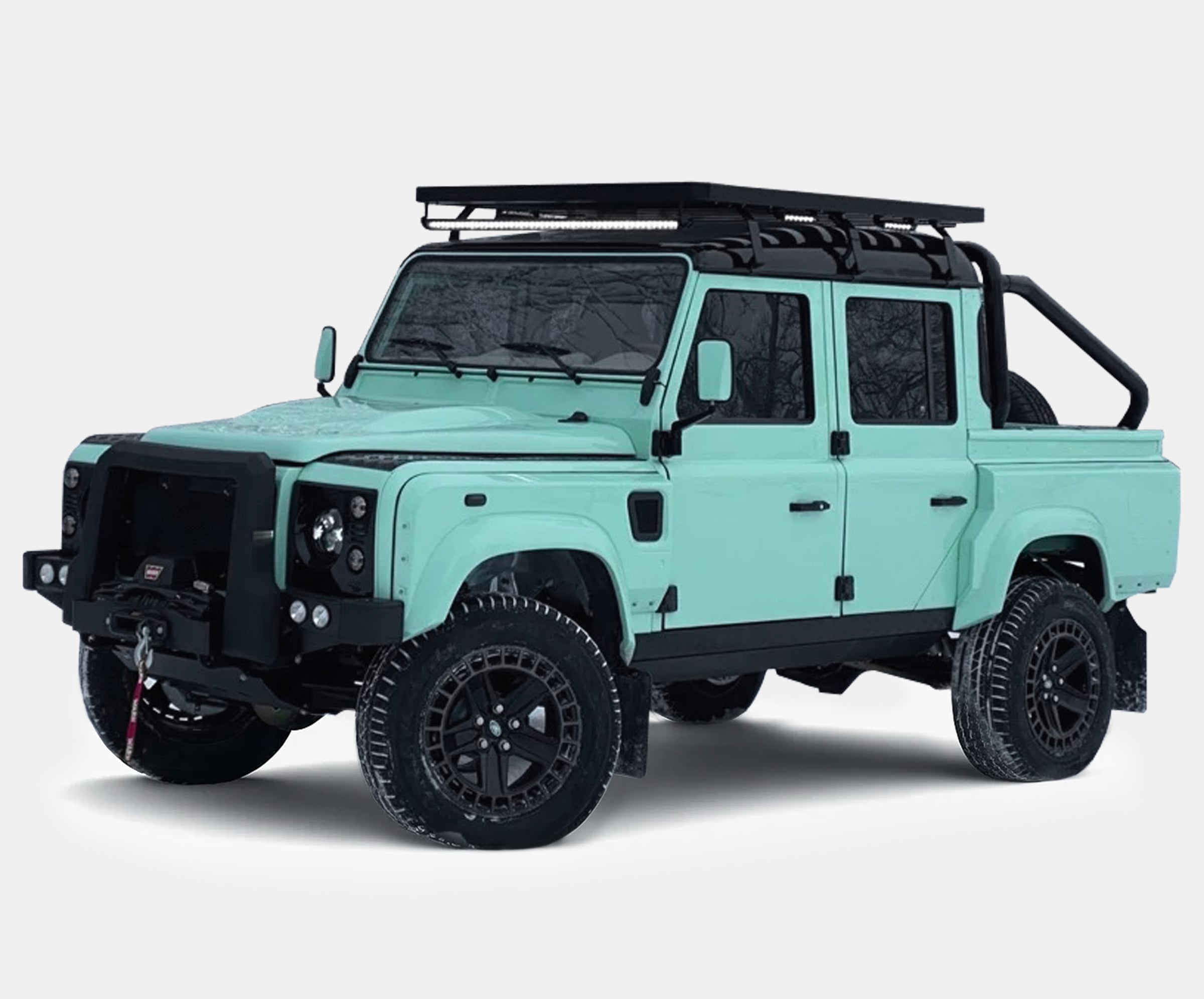 A bespoke Land Rover Defender in mint green color with off-road features