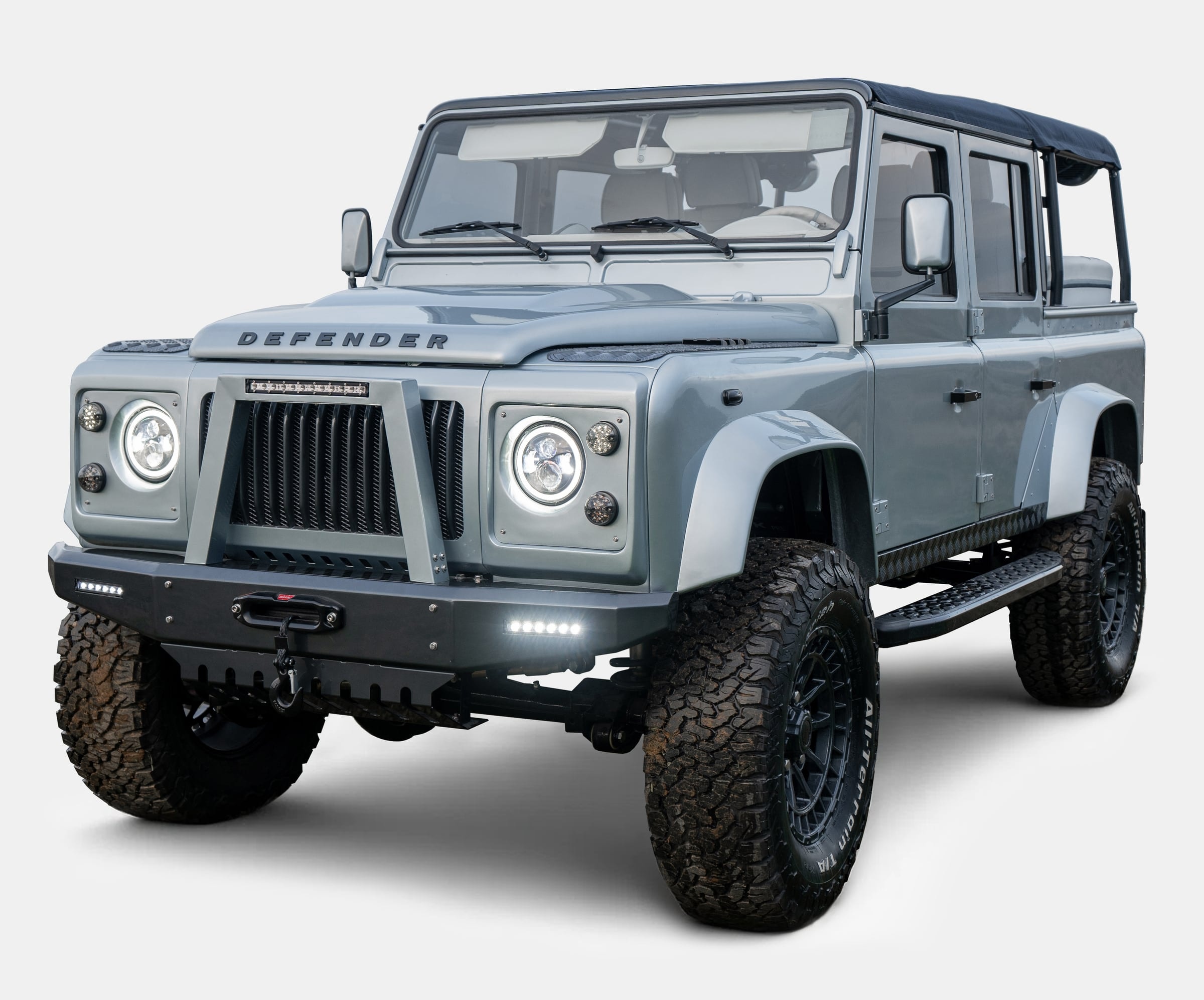 Custom Land Rover Defender in a sleek gray finish with off-road tires and a modern grill design