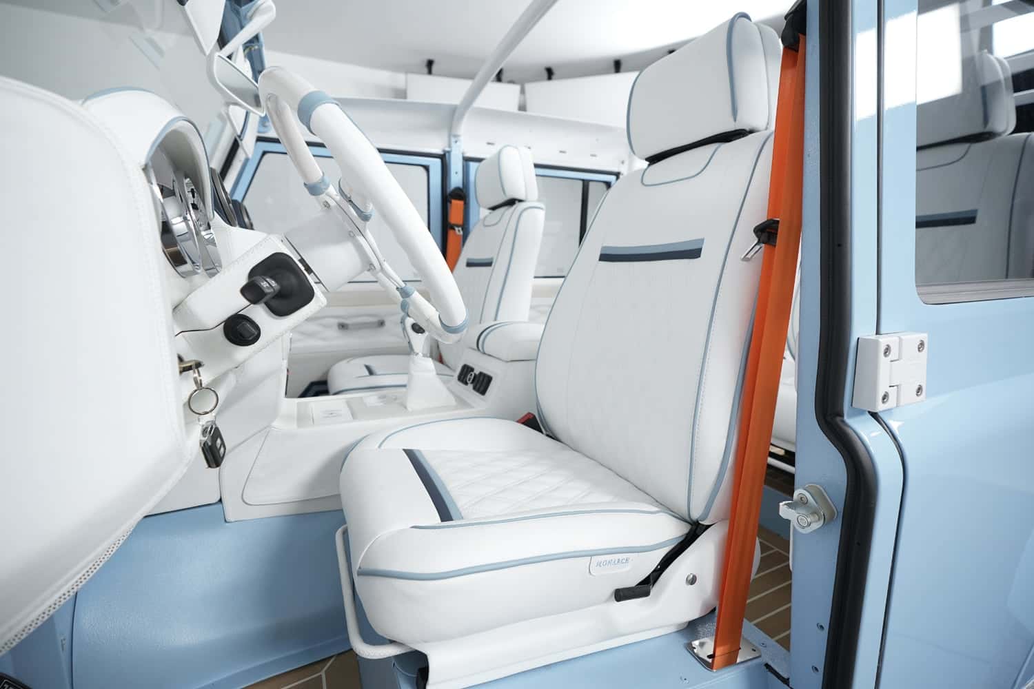 Interior Shot: Luxe Seating Design Interior view of a luxury Land Rover Defender with white and blue leather seats