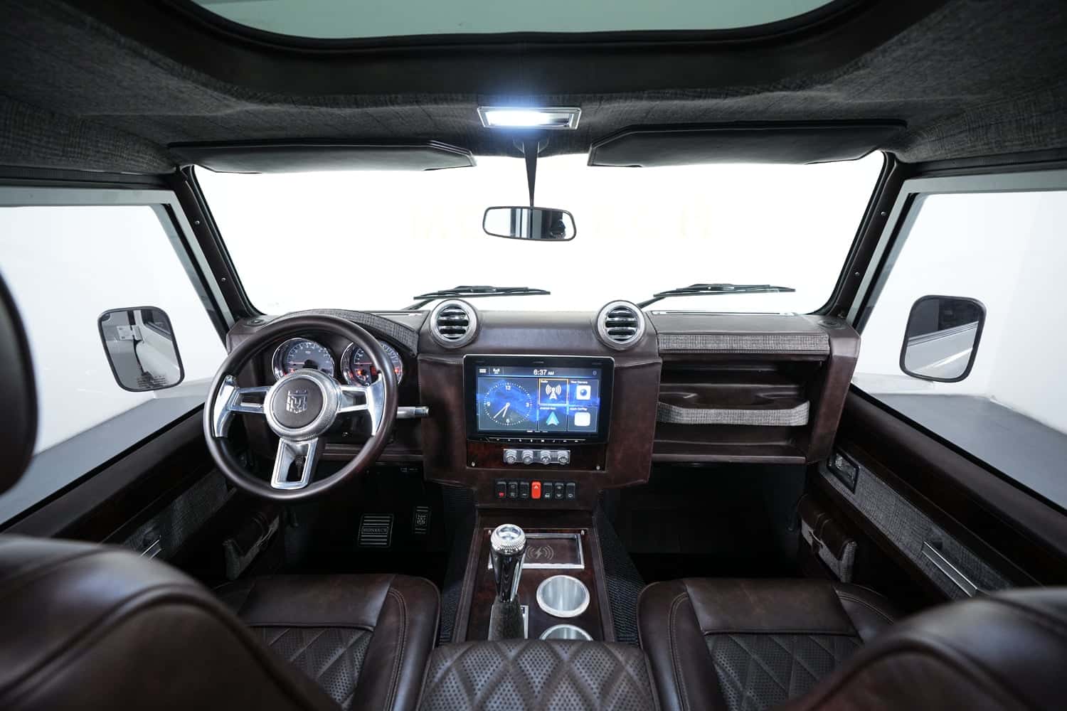 Interior Shot: Bespoke Cabin Design Luxury Land Rover Defender interior featuring leather seats and modern dashboard