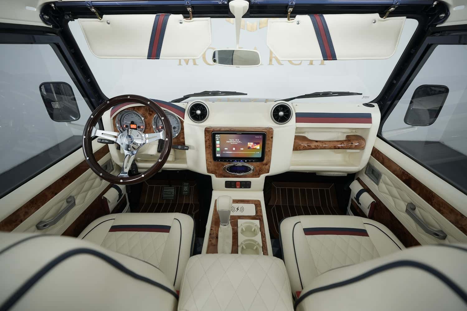 Interior Shot: Luxury Cabin Design Bespoke Land Rover Defender interior featuring cream leather, wooden accents, and modern technology