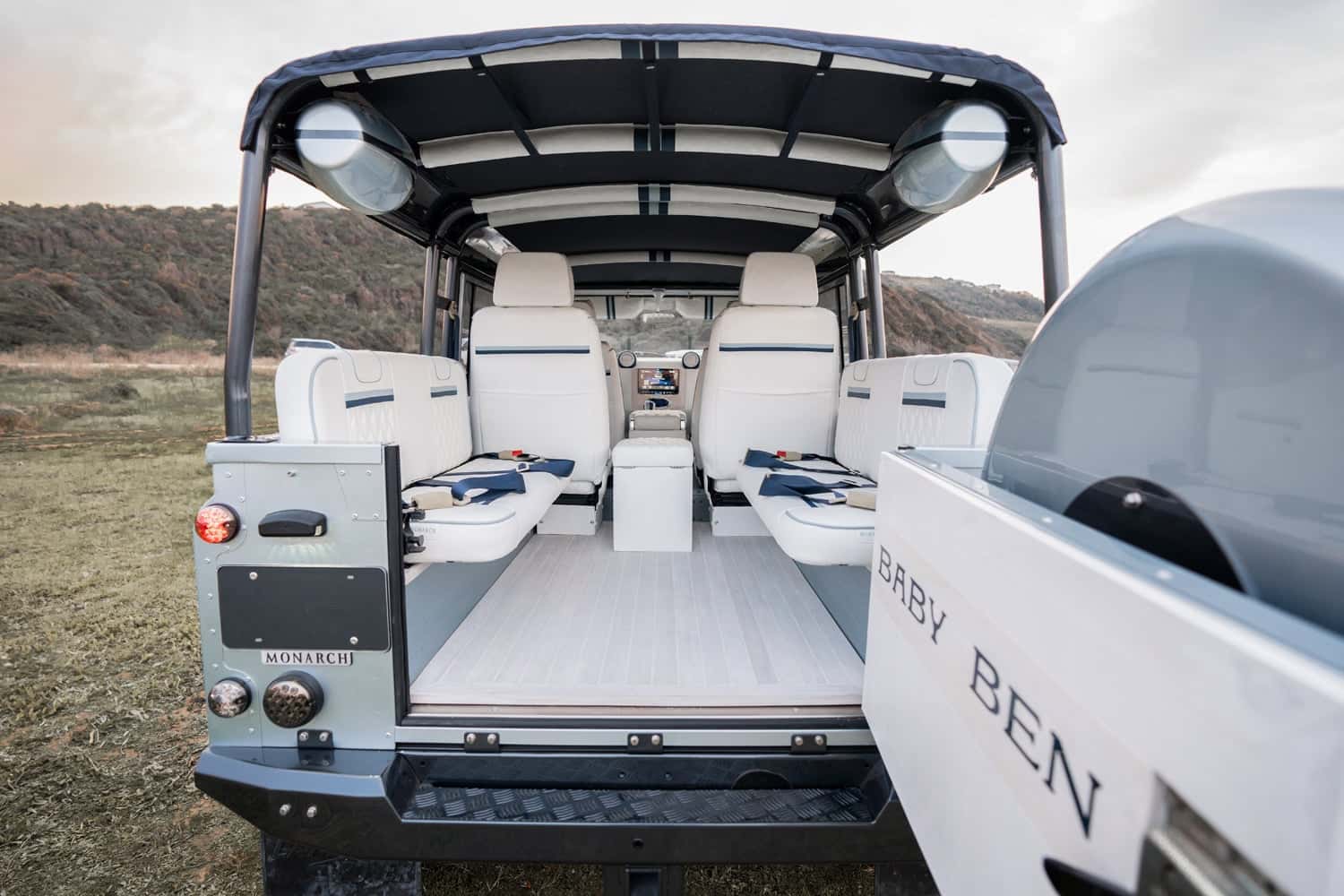Interior Shot: Luxury Seating Interior of a custom Land Rover Defender featuring luxury white seating and modern design elements