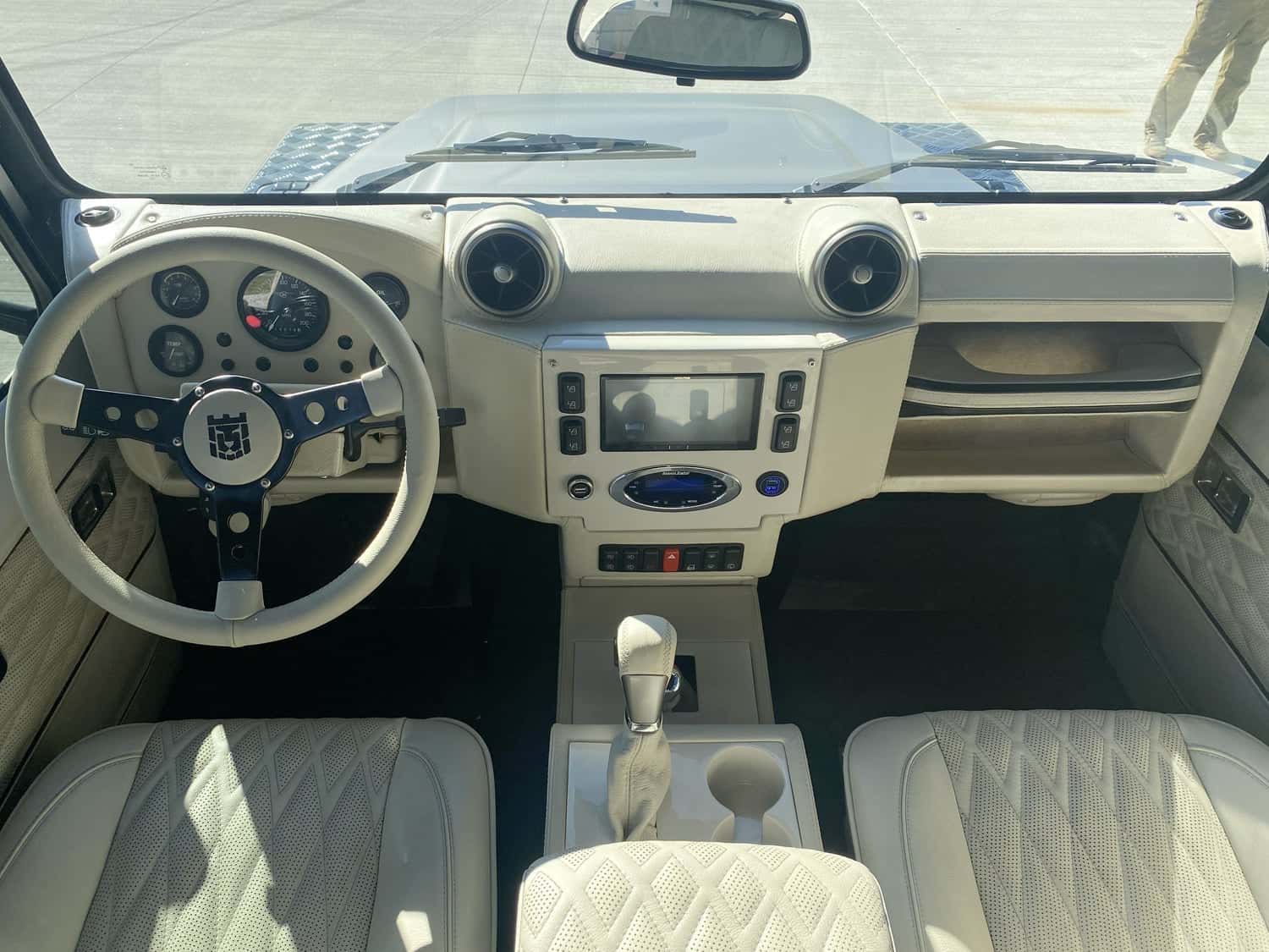 Interior Shot: Luxury Cabin Luxurious interior view of a custom Land Rover Defender, featuring a stylish dashboard and leather seats