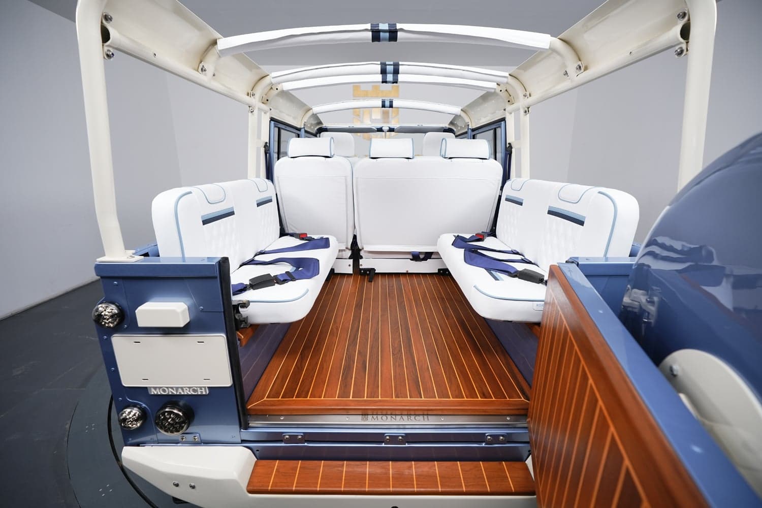 Interior Shot: Luxury Cabin Space Interior view of a luxury Land Rover Defender with white upholstery and wooden floor