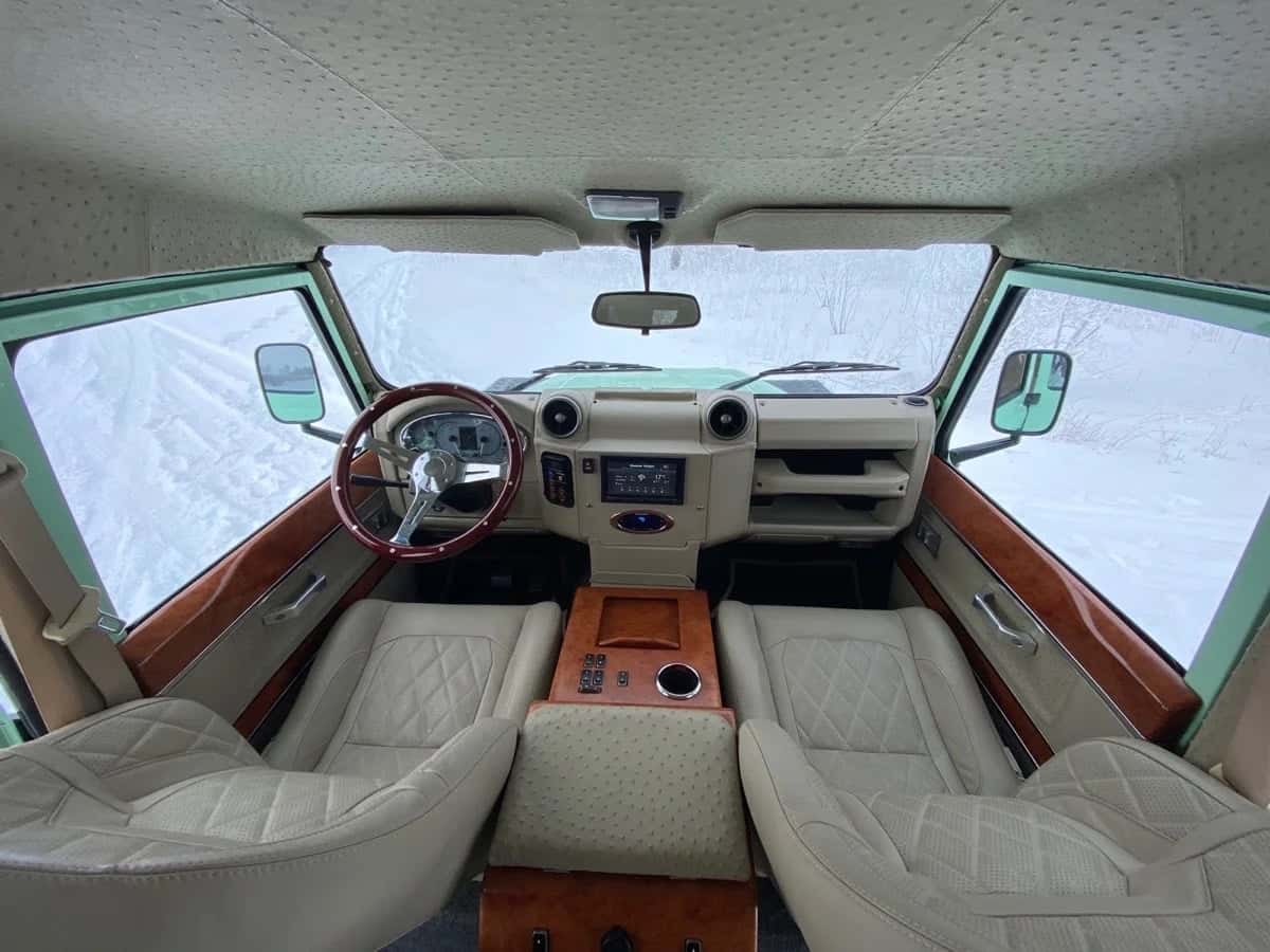 Interior Shot: Luxury Cabin Design Bespoke interior of a custom Land Rover Defender with leather seats and wood accents
