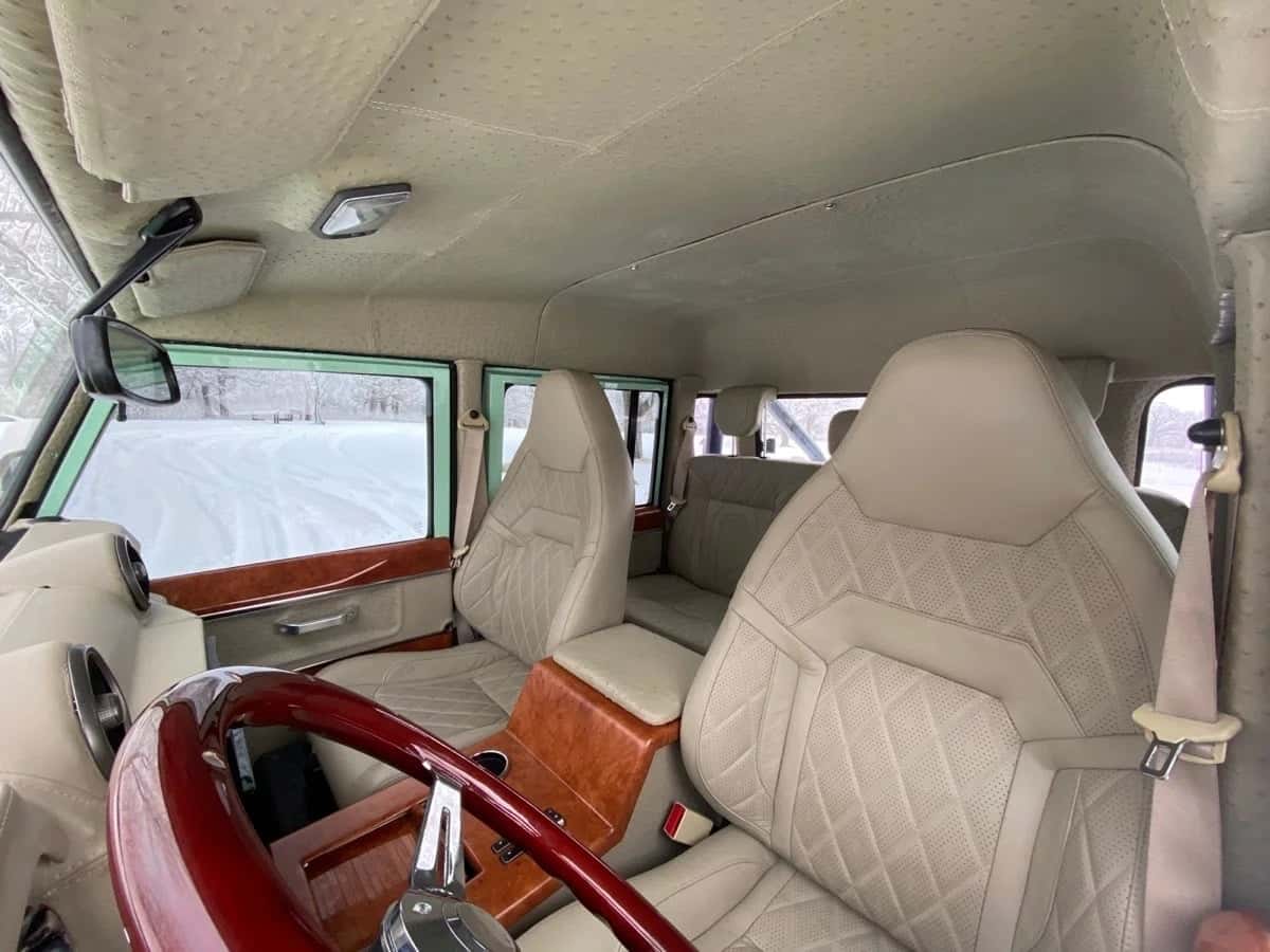 Interior Shot: Luxurious Cabin Interior view of a custom Land Rover Defender featuring premium leather seats and wood accents