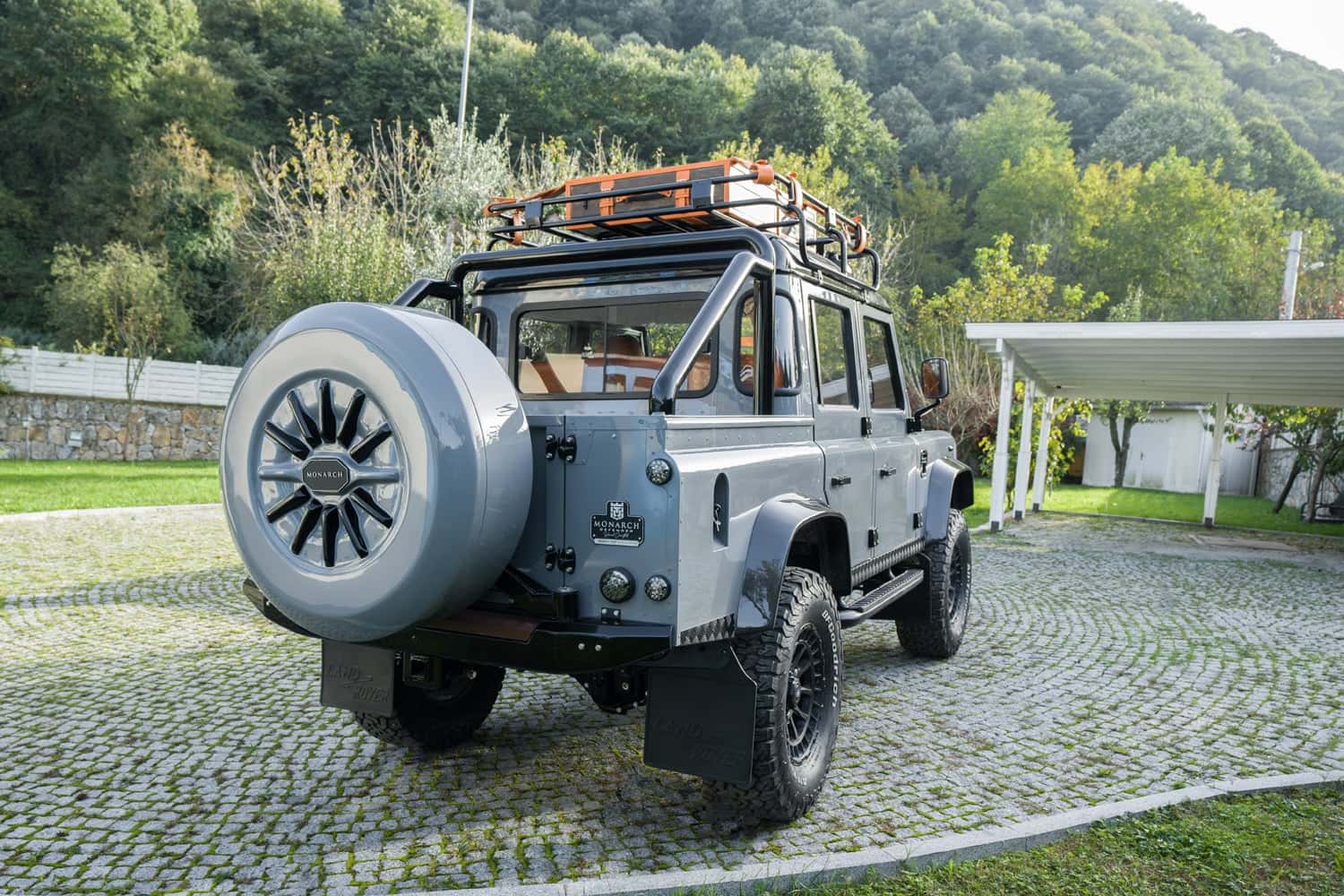 Rear View: Bespoke Land Rover Defender Rear view of a custom Land Rover Defender with a grey finish and off-road tires
