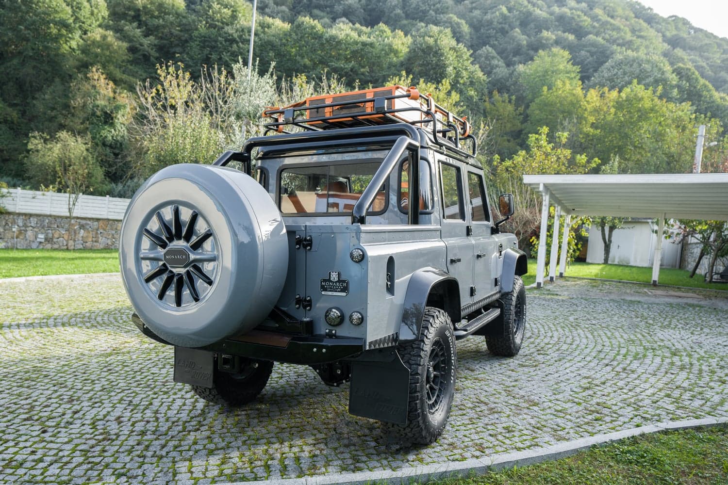 Rear View: Bespoke Land Rover Defender Rear view of a custom Land Rover Defender with a grey finish and off-road tires